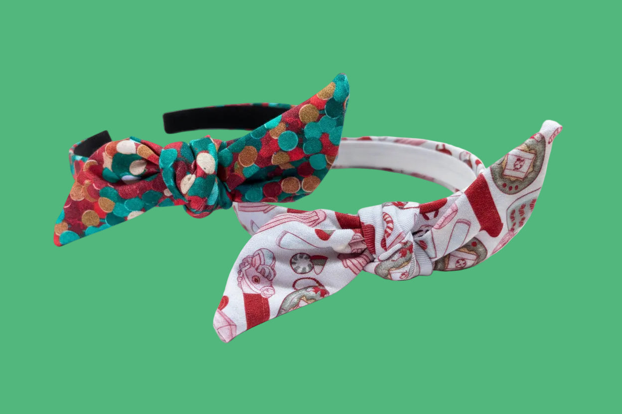 Two Handmade and ready to ship twisted bow headbands with designs in Christmas dots and Stocking Stuffers. Fabric is a soft and stretchy cotton Lycra fabric on universal sized headbands. 