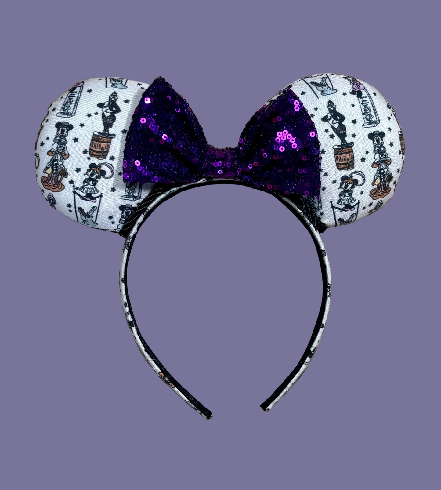 A set of ears with a fab 5 stretching room fabric on the ears front and back along with the headband as well. Black twisted trim along the inner ears with a purple sequin bow. 