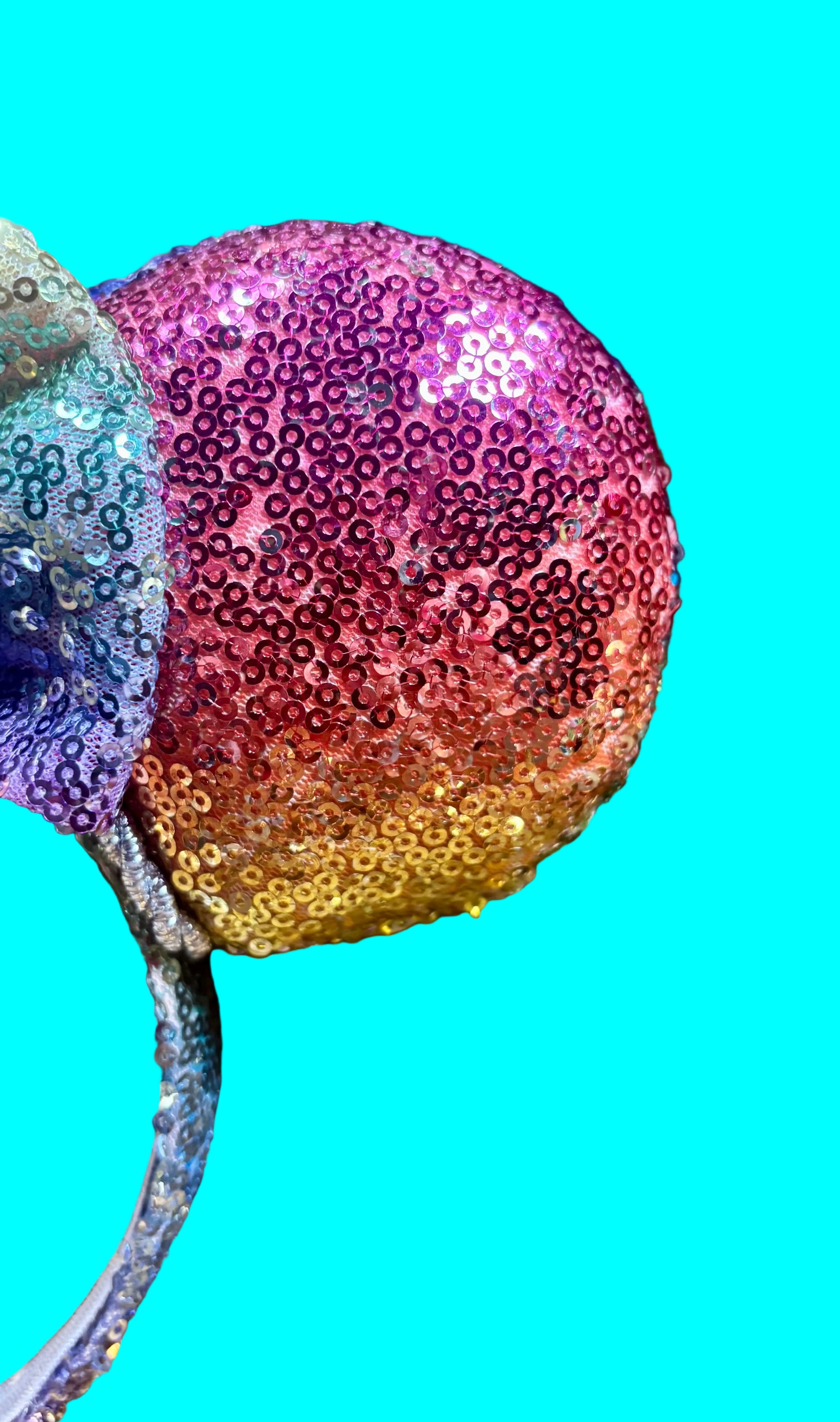 Handmade and ready to ship Rainbow sequin mouse ears. Front closeup view of fabric.
