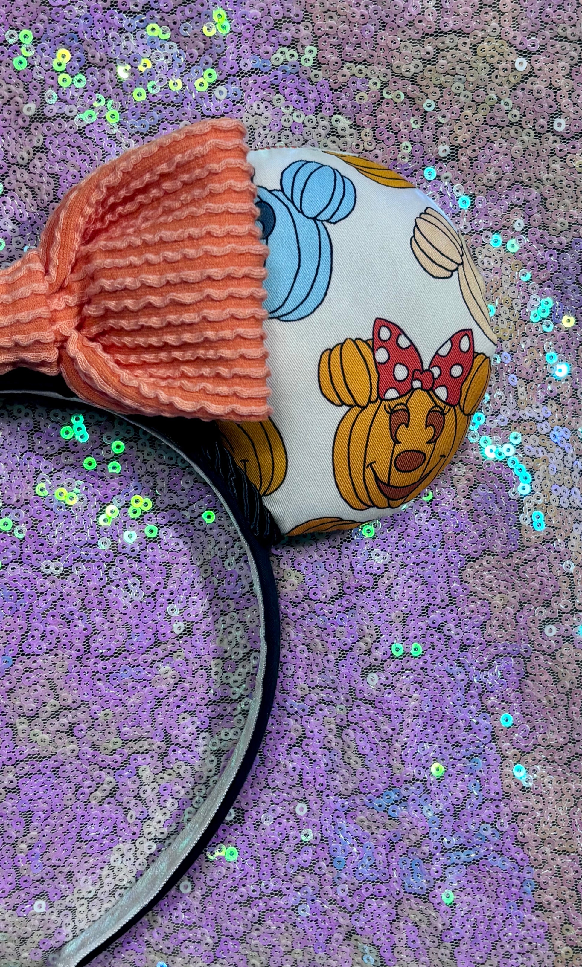 Right front ear view with pumpkins on the fabric and an orange waffle knit bow