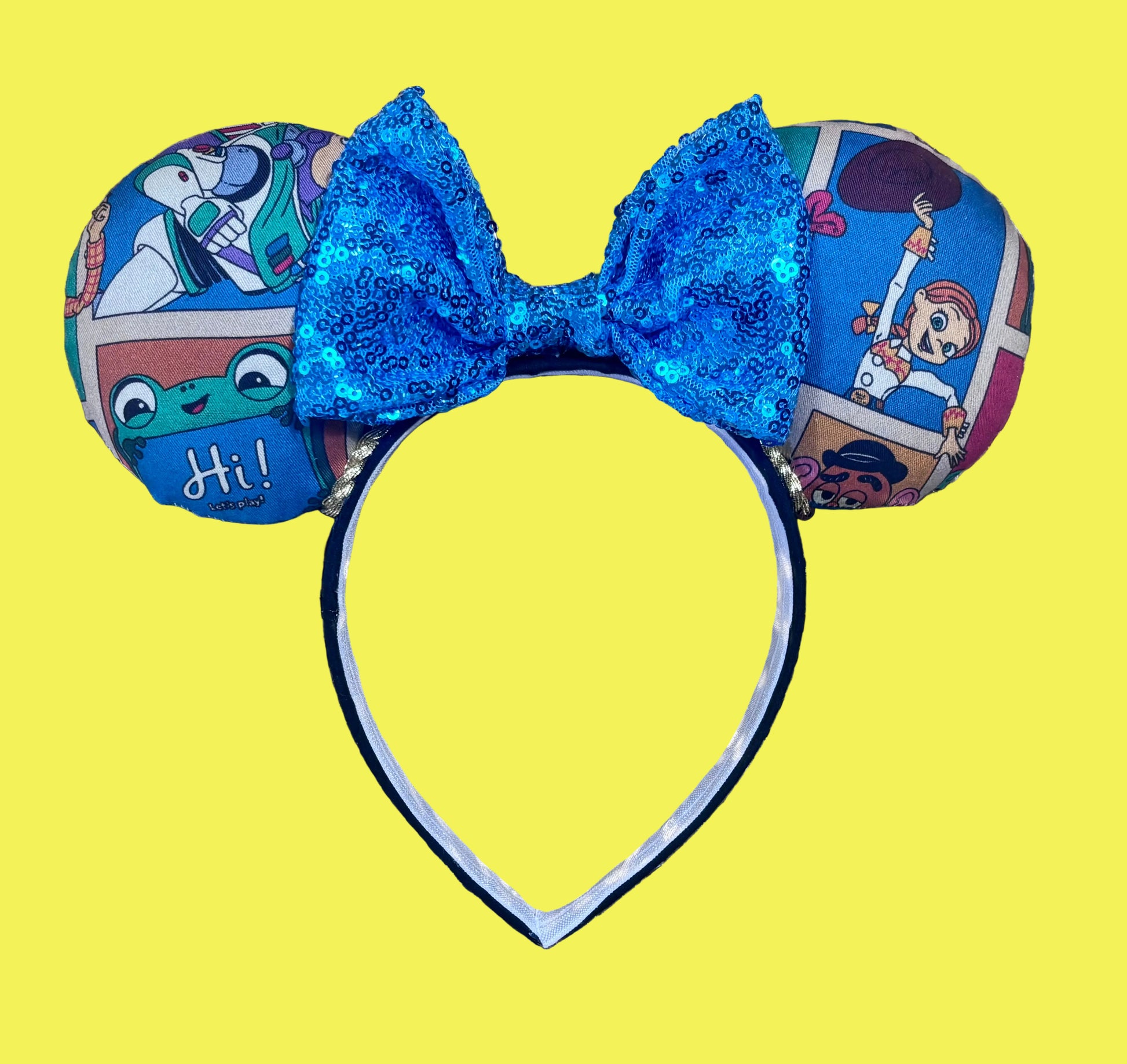 Handmade and ready to ship TS5 Inspired mouse ears. The character fabric is on the front and the back. On a universal sized black poly fabric headband. With blue sequin bow.
