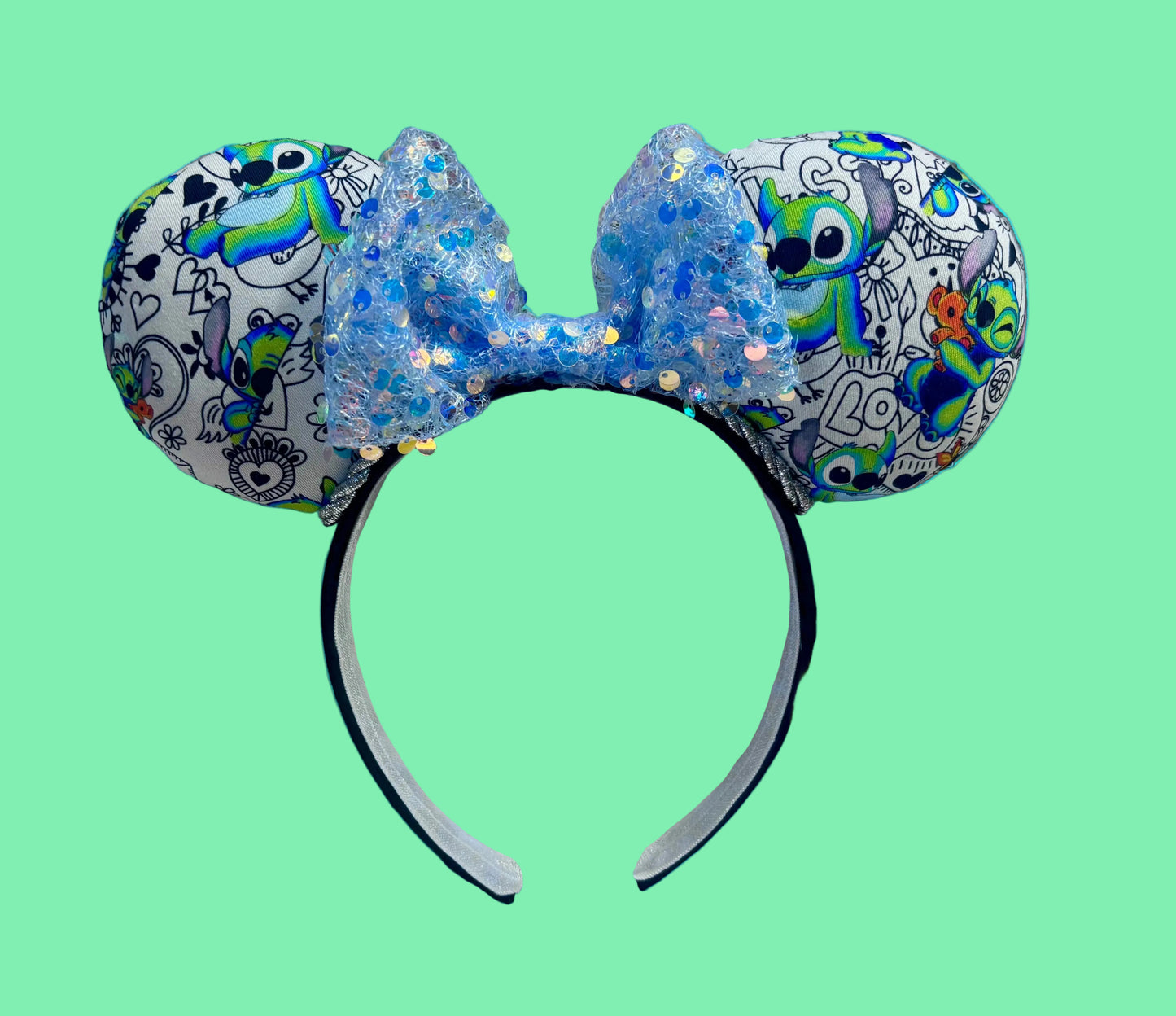 Handmade and ready to ship Mouse ears with Stitch cartoon character design and a blue sequin bow.