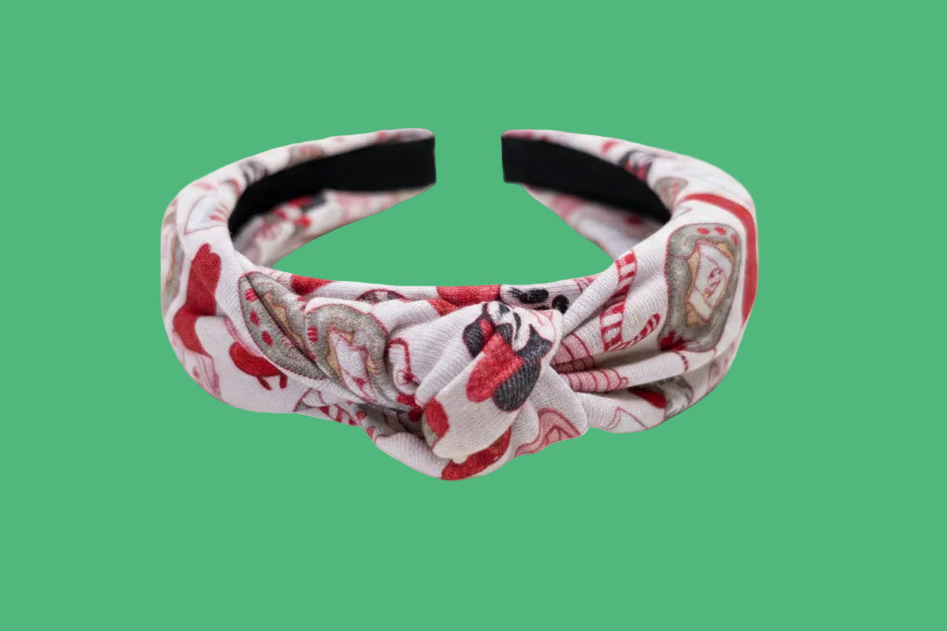 Headband with red, pink and white Stocking Stuffer pattern on a white background.