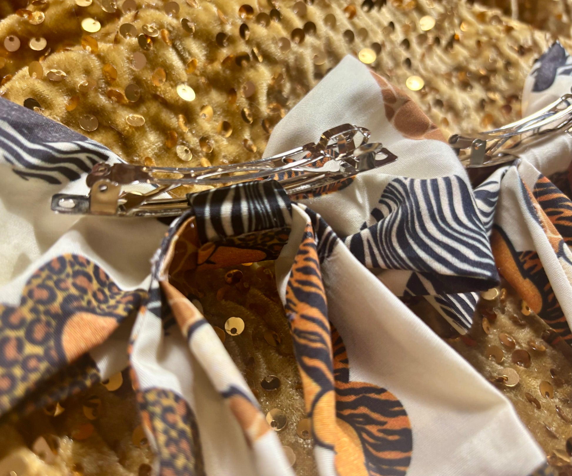 Close-up of a decorative hair clip with various patterns on a textured background