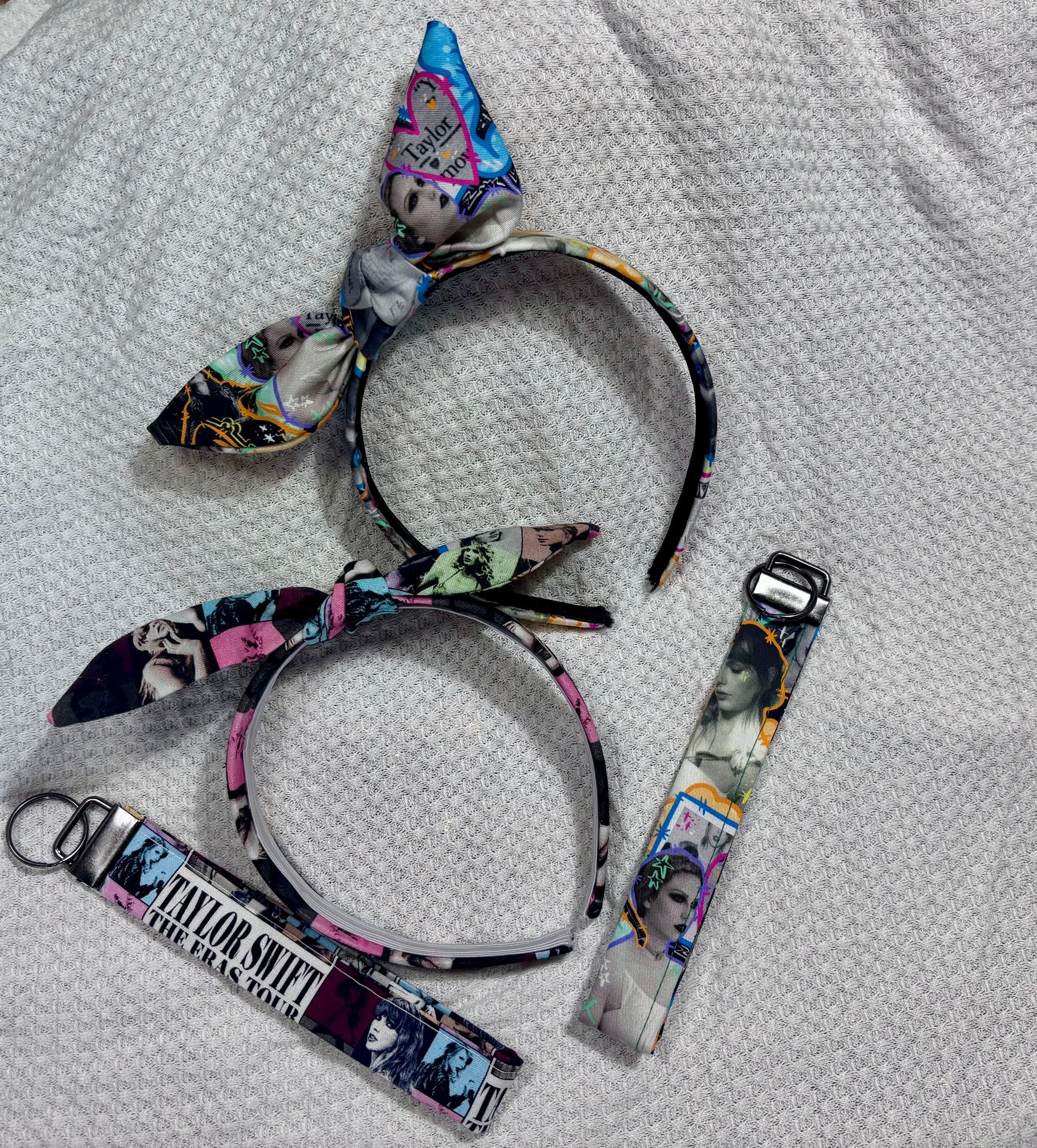 Set of headbands and lanyards with Taylor Swift design on a textured surface