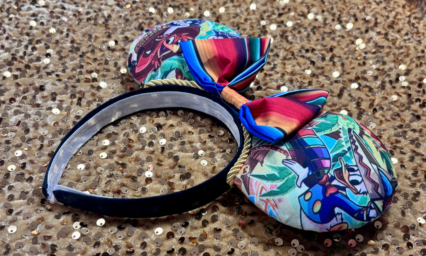 Side view of mouse ears. Colorful Handmade mouse ears with a colorful bow on a white background with duck cartoon images on the ears. Handmade and ready to ship. 
