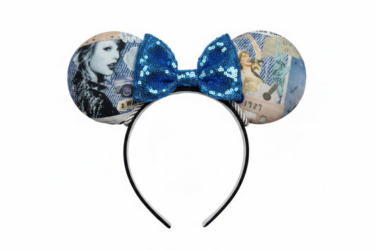 Mouse ear headband with blue sequin bow and vintage-style design on a white background