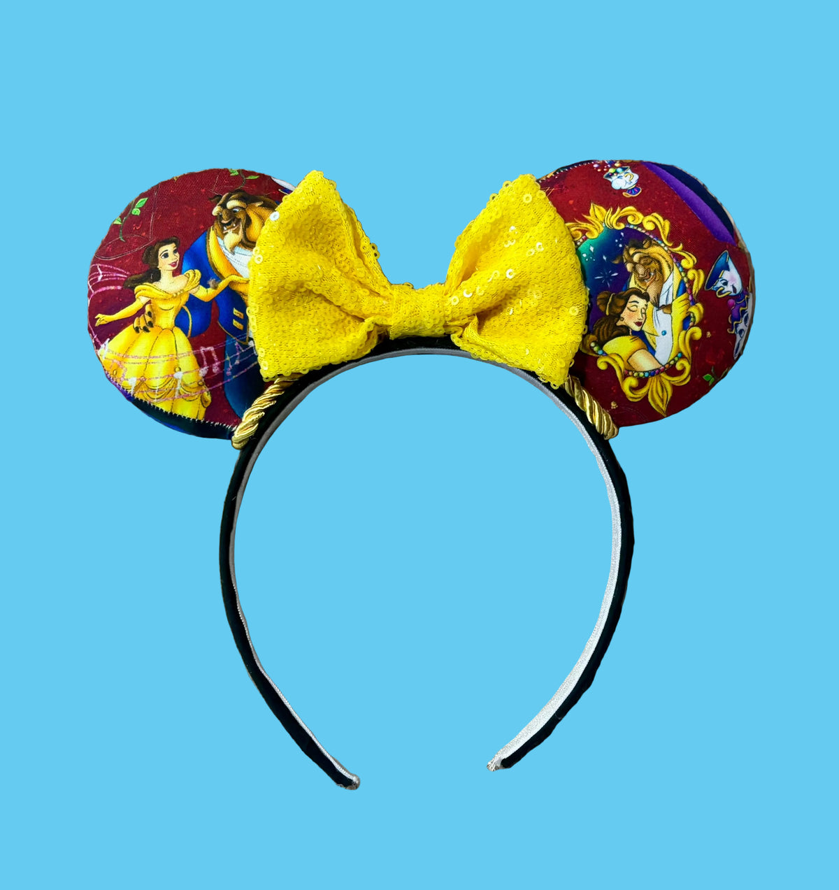 Handmade ear headband featuring a large yellow bow and multicolor print with Belle and the Beast.