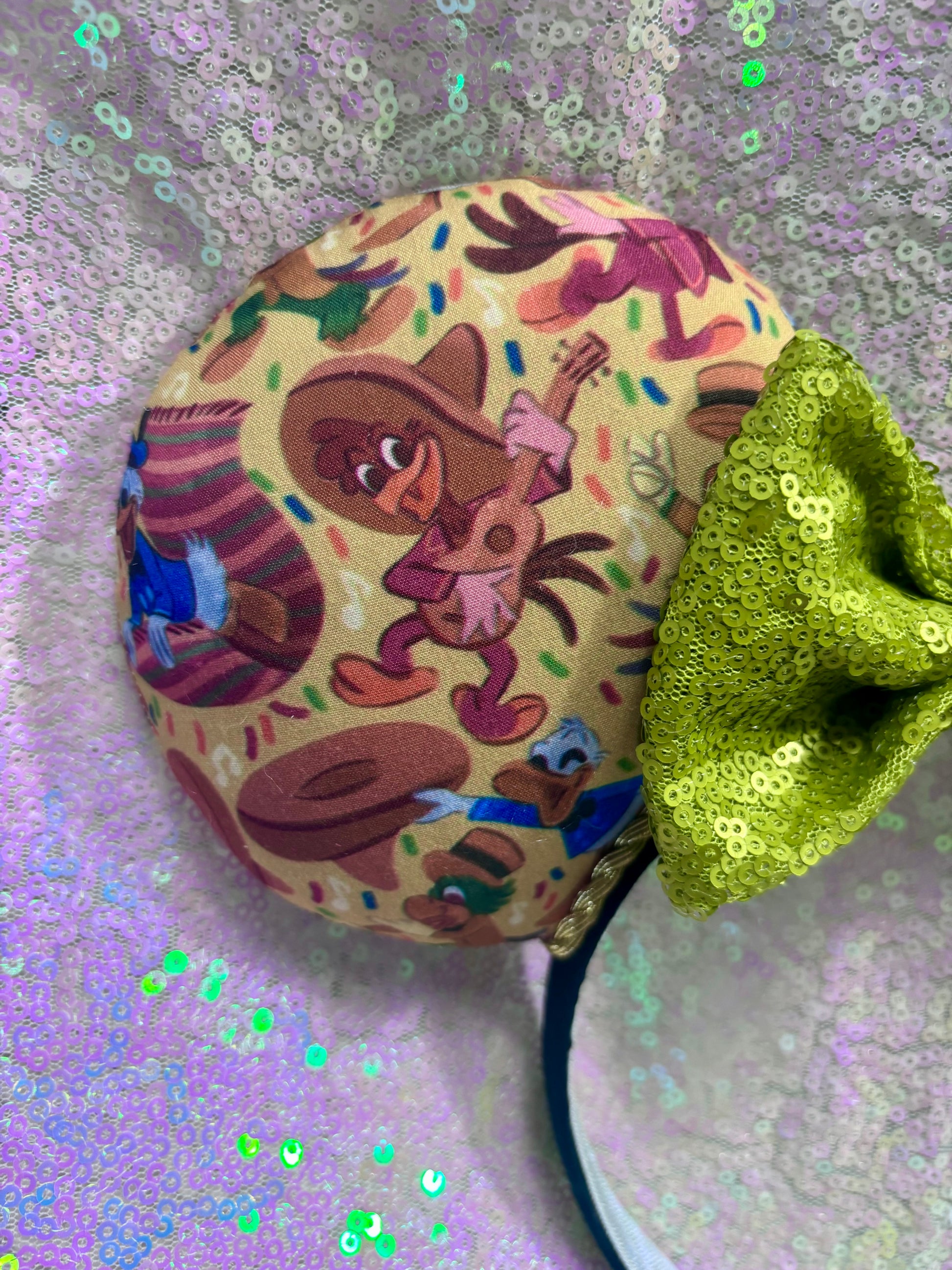 Handmade and ready to ship. These are perfect for Epcot. Three Caballero themed with a lime green sequin bow on a headband making mouse ears. Shown on a white background.