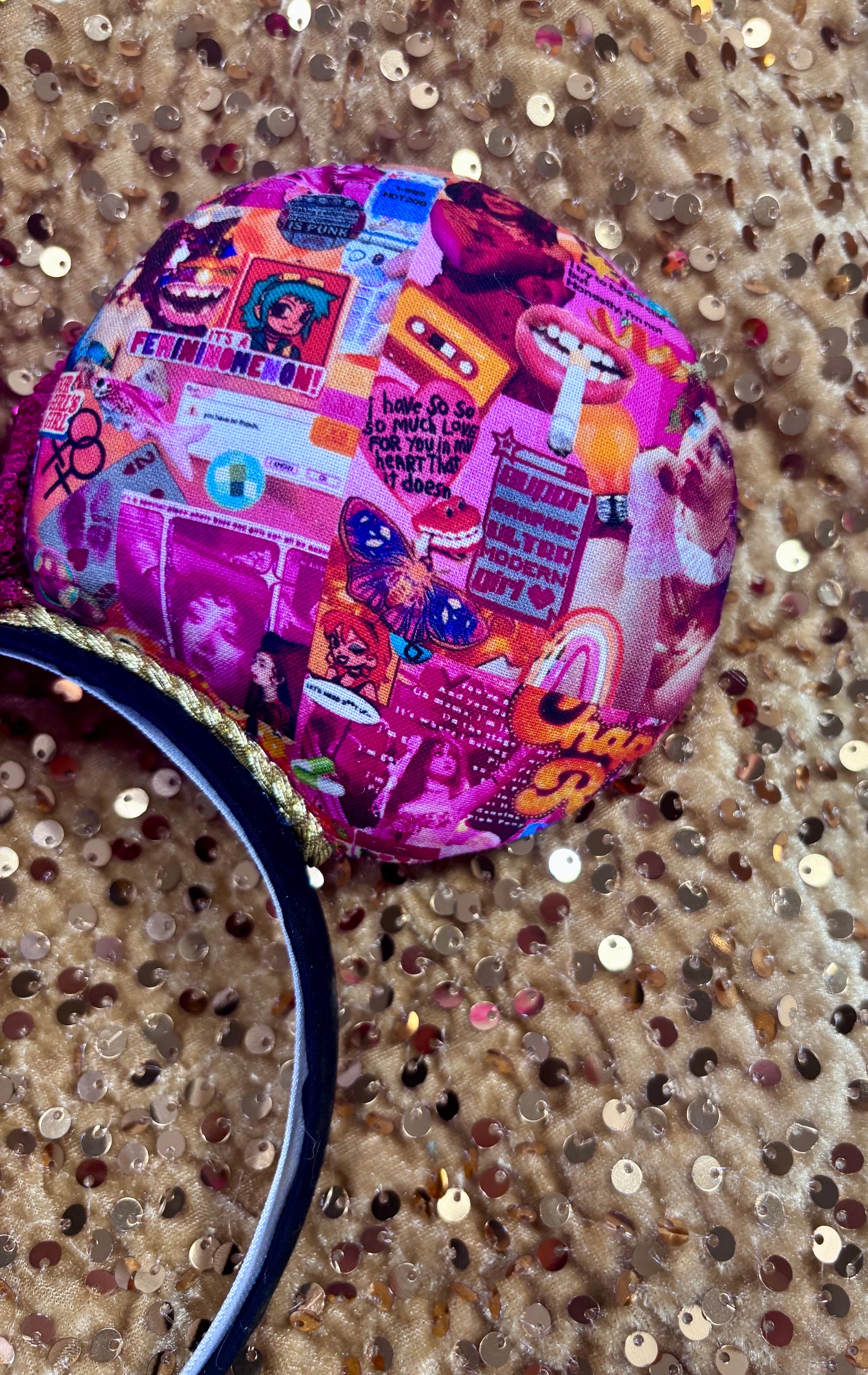 Handmade and ready to ship Colorful Chappell inspired Mouse ears with a hot pink bow on a headband against a gold sequin background.