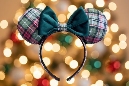 Green Plaid mouse ears with a green velvet bow. Shown against a blurred lights background