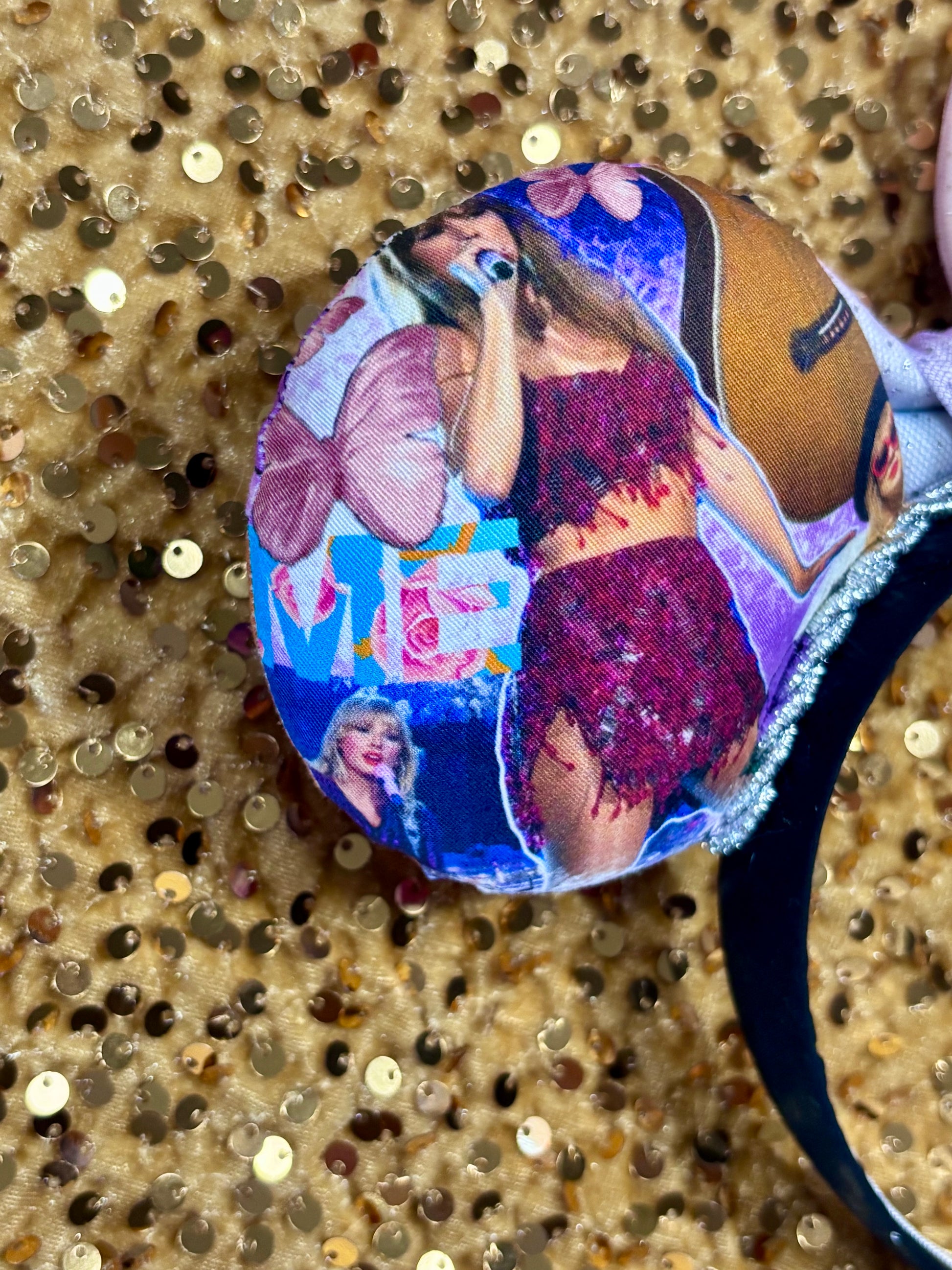 Back left close up of mouse ear. Handmade and ready to ship TS Mouse ears with a new beautiful sewn tulle bow with sparkles on it. Of course, you can still request any bow in sequin if you prefer and I will attach it. Shown on a gold sequin background.