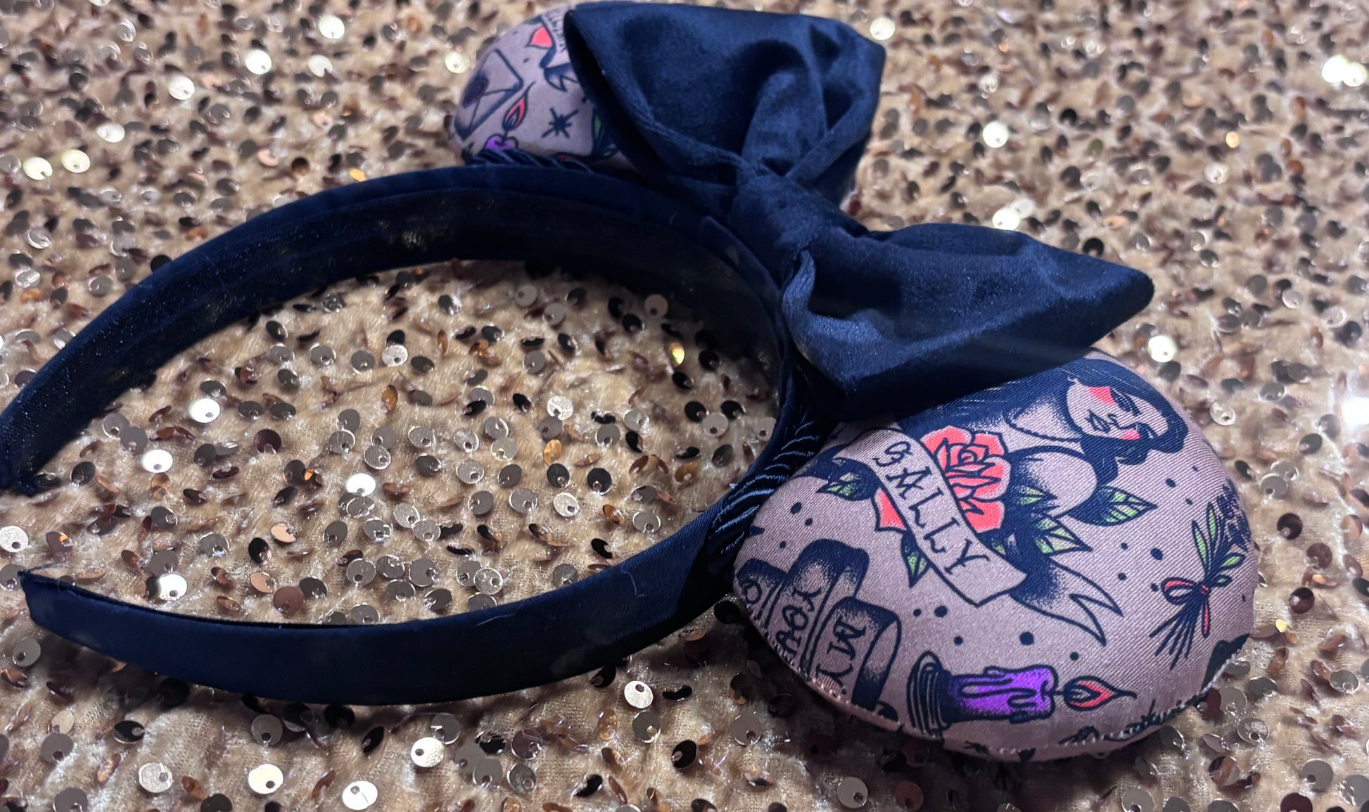 The other side view of the headband. Handmade and ready to ship Practically Magical Mouse ears with the fabric on the ears, front and back and a black velvet bow. The headband is a universal sized headband and has black poly cotton fabric on it.