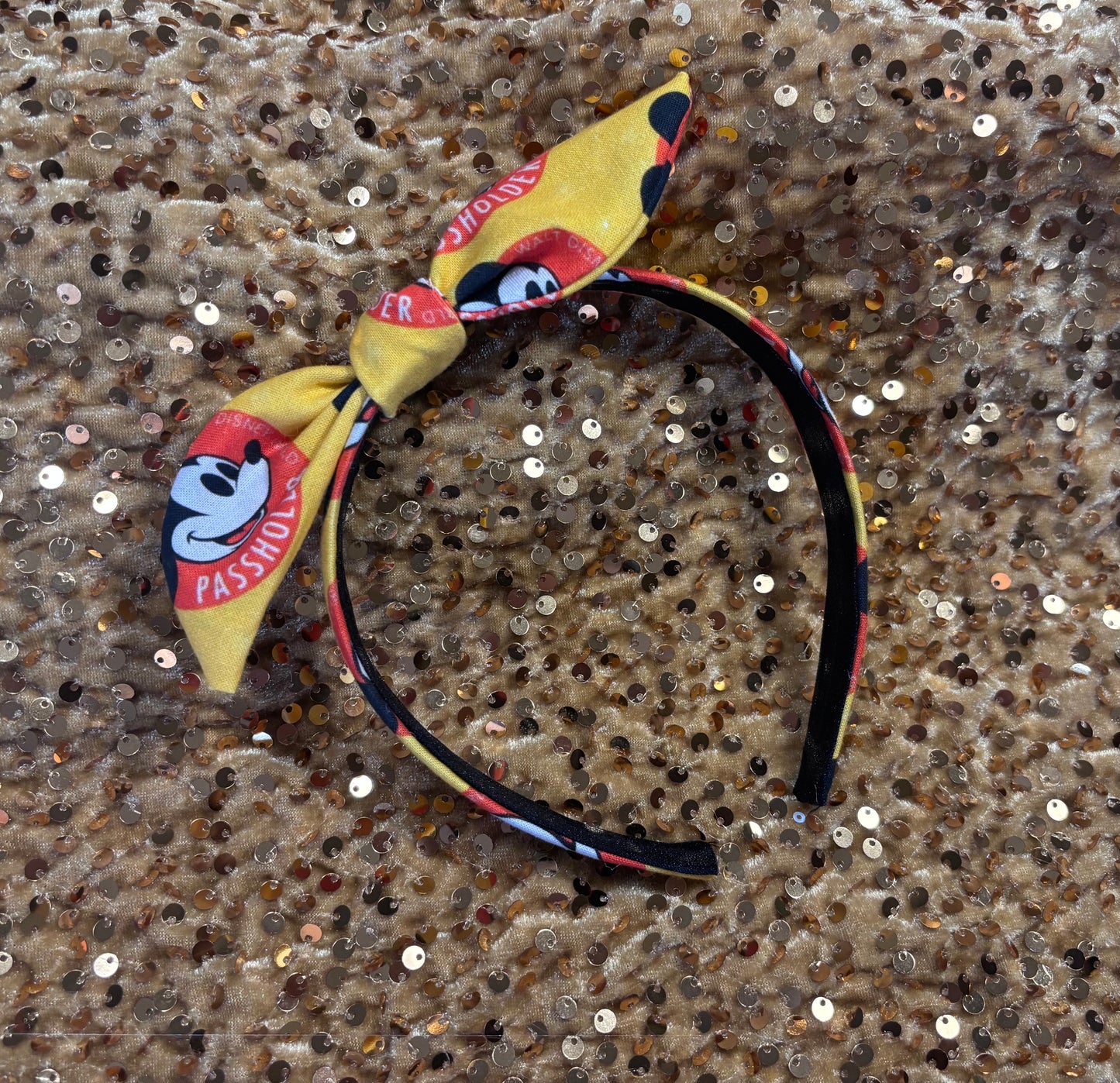 Headband with cartoon character and AP design on a textured surface
