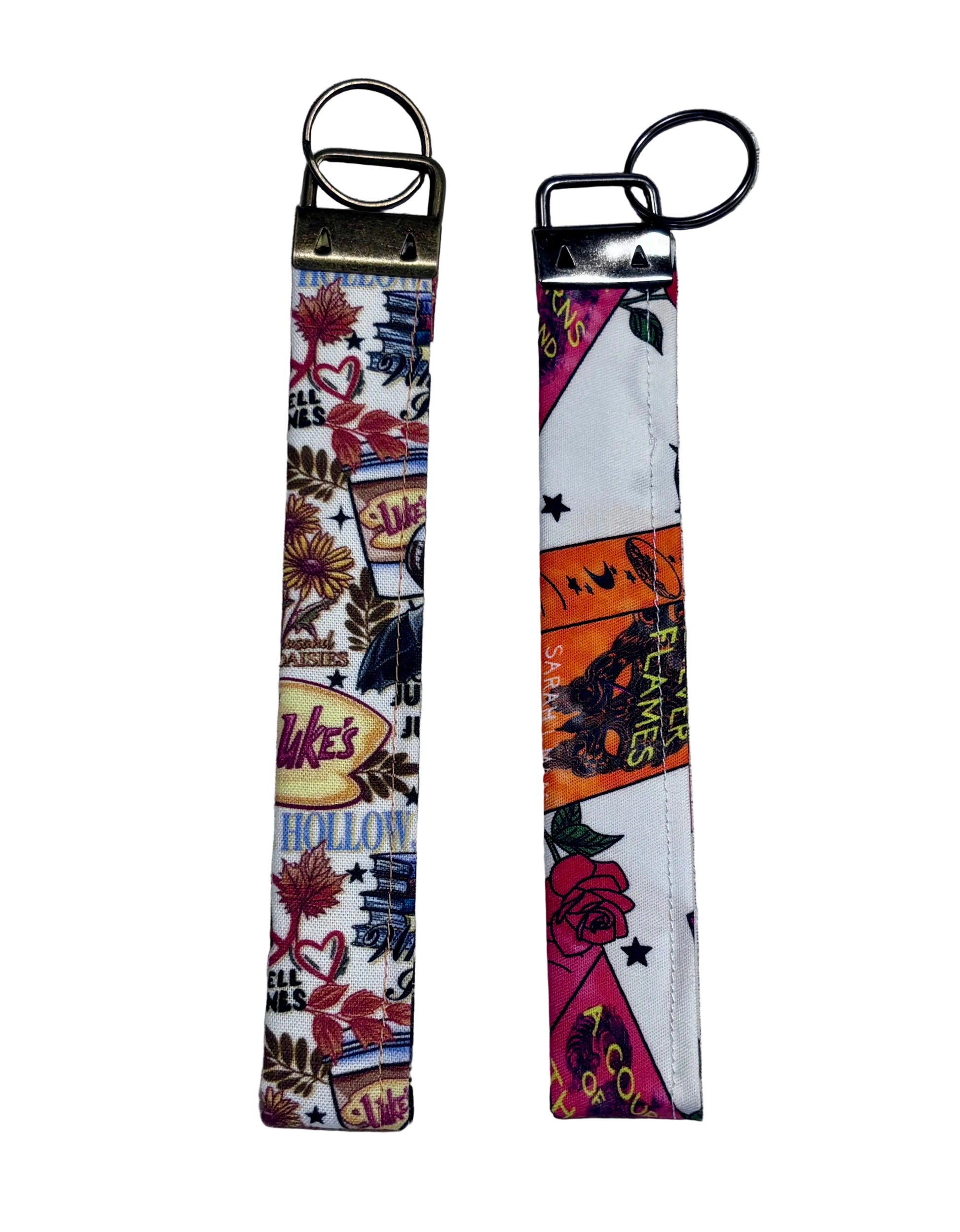 Two keychains with colorful designs on a textured gray background