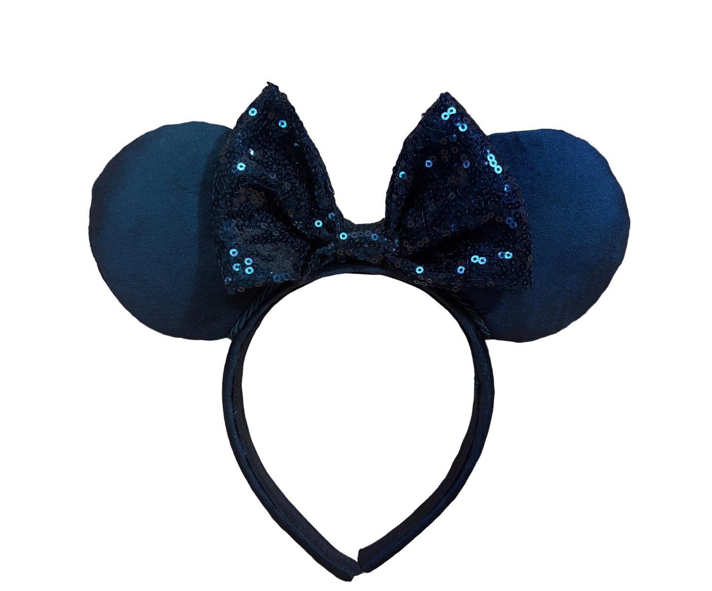 Black mouse ears with sequin bow on a beige background