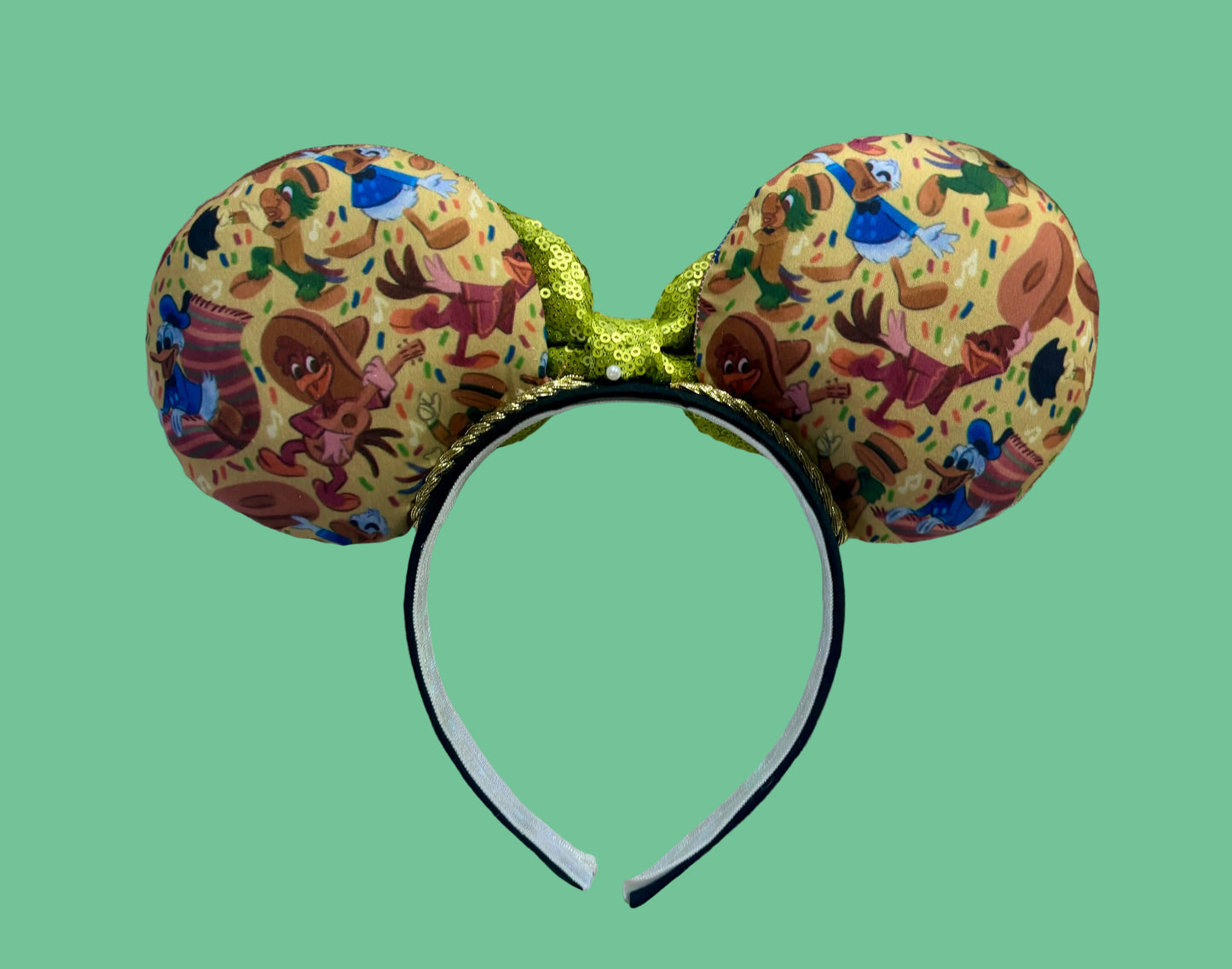 Handmade and ready to ship. These are perfect for Epcot. Three Caballero themed with a lime green sequin bow on a headband making mouse ears. Back view of the mouse ears.