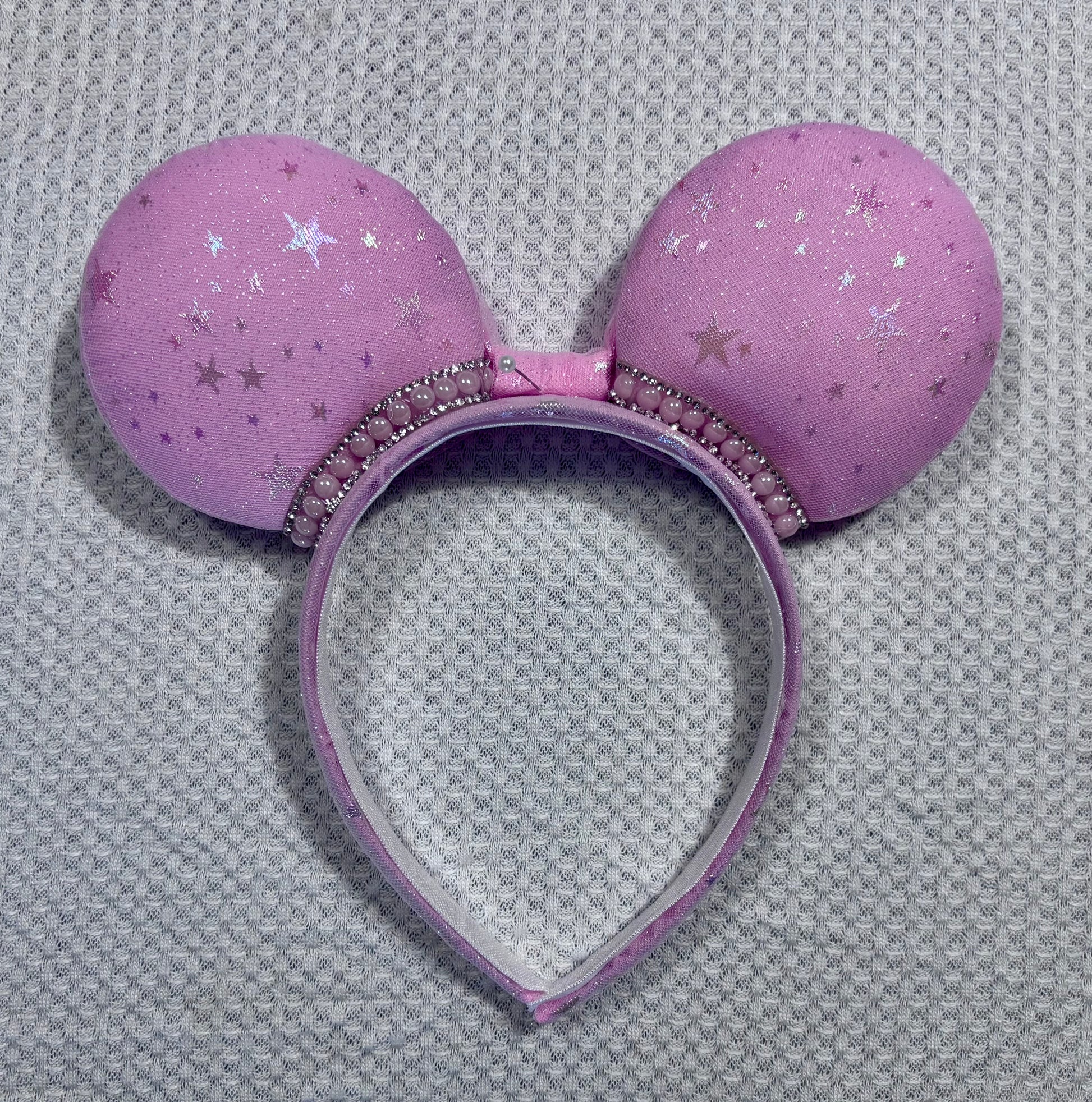 Back view of mouse ears showing the same fabric as the front and more of the rhinestone trim.