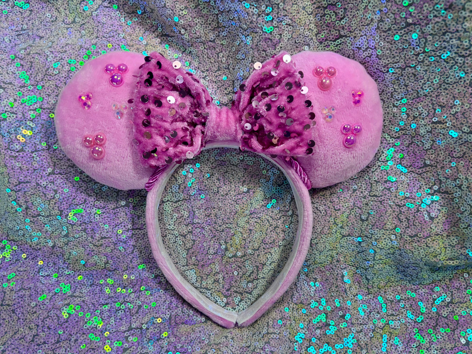Pink plush mouse ears with gemstone hidden mickeys and a pink sequin bow
