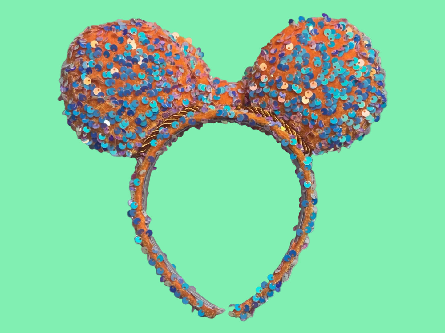 Back view of custom Handmade and ready to ship ears! Sequined bow headband has orange velvet soft fabric with mint sequin sparkles on it. The fabric is on the ears front and back, the bow and the headband as well. Orange twisted trim along the inner ears and set on a universal sized headband.