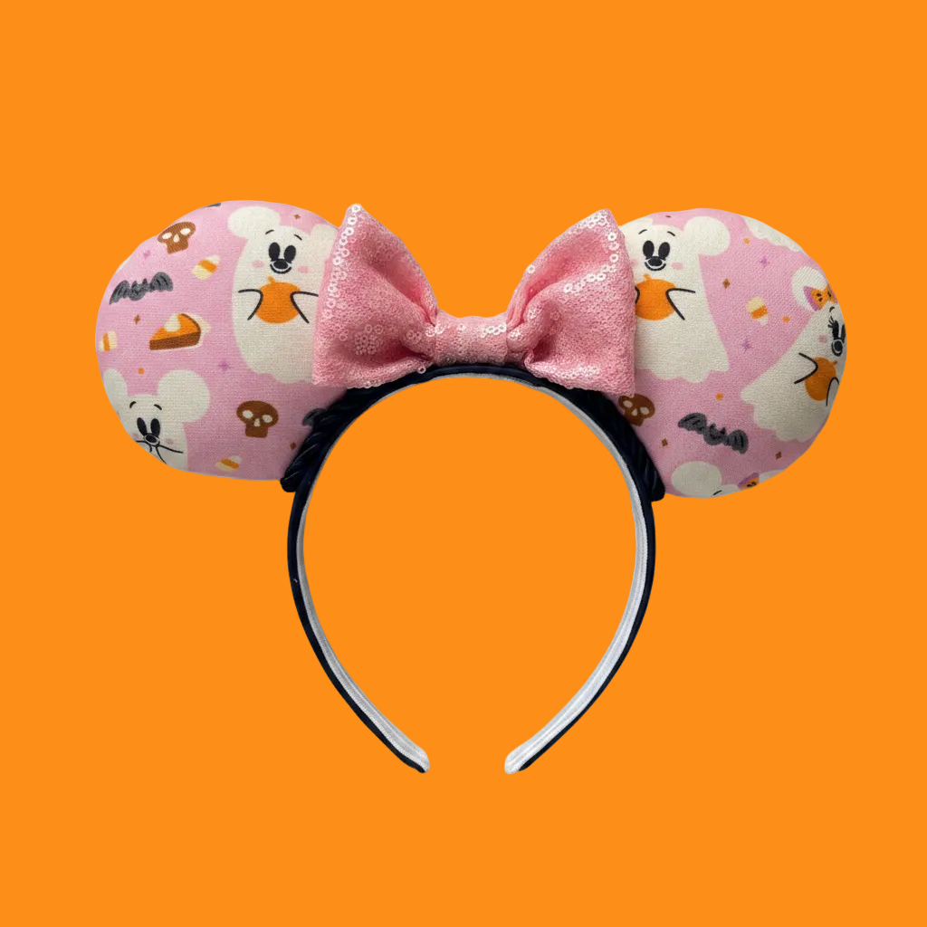 Handmade and ready to ship Halloween Pink Ghosts Mouse ears with the fabric with mouse shaped ghosts on pink fabric is on the ears, front and back and a light pink sequin bow. The headband is a universal sized headband and has black poly cotton fabric on it.