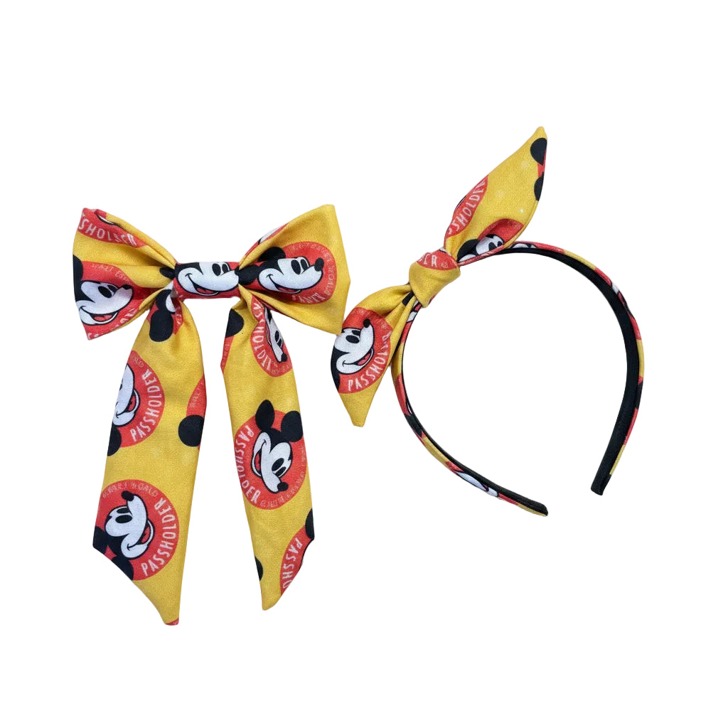 Handmade and ready to ship hair bow and twisted bow headband with cartoon character design with AP logo.