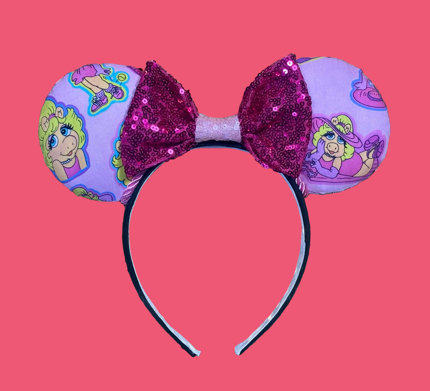 Handmade and ready to ship Piggy mouse ears. Miss Piggy fabric is on the front and the back. On a universal sized black poly fabric headband.