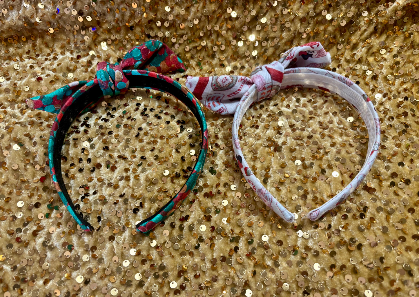 Two Handmade and ready to ship twisted bow headbands with designs in Christmas dots and Stocking Stuffers. Fabric is a soft and stretchy cotton Lycra fabric on universal sized headbands. Inner headband view.