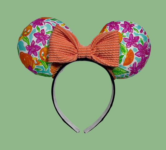 Pink, White, Blue and of course Orange on these handmade and ready to ship Orange Bird themed mouse ears with an orange waffle bow. Shown on a white background.