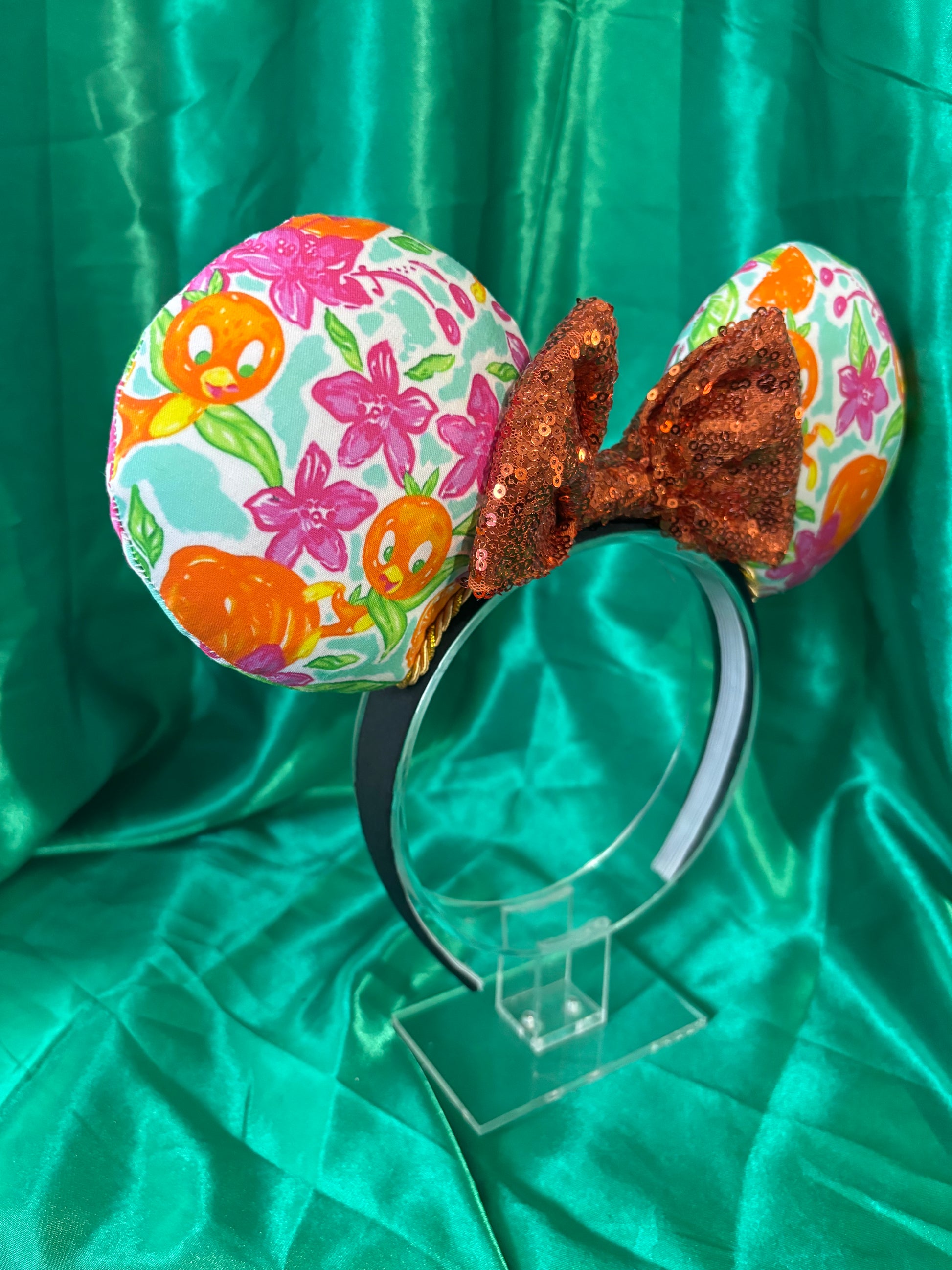 mouse ears from a side view on a black headband with green sating background