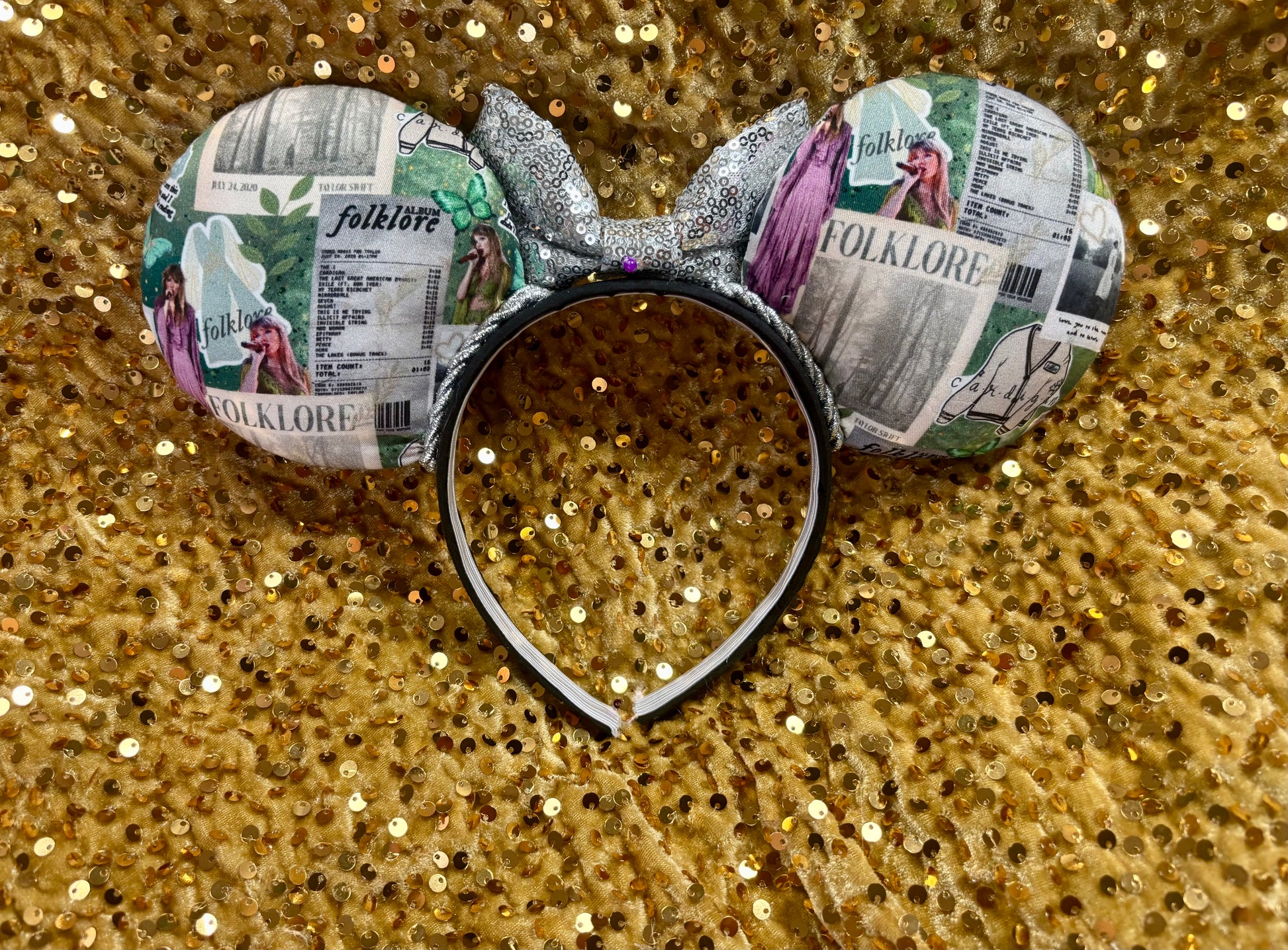 Back of Mouse ears with folklore inspired design. Shown on a glittery gold background