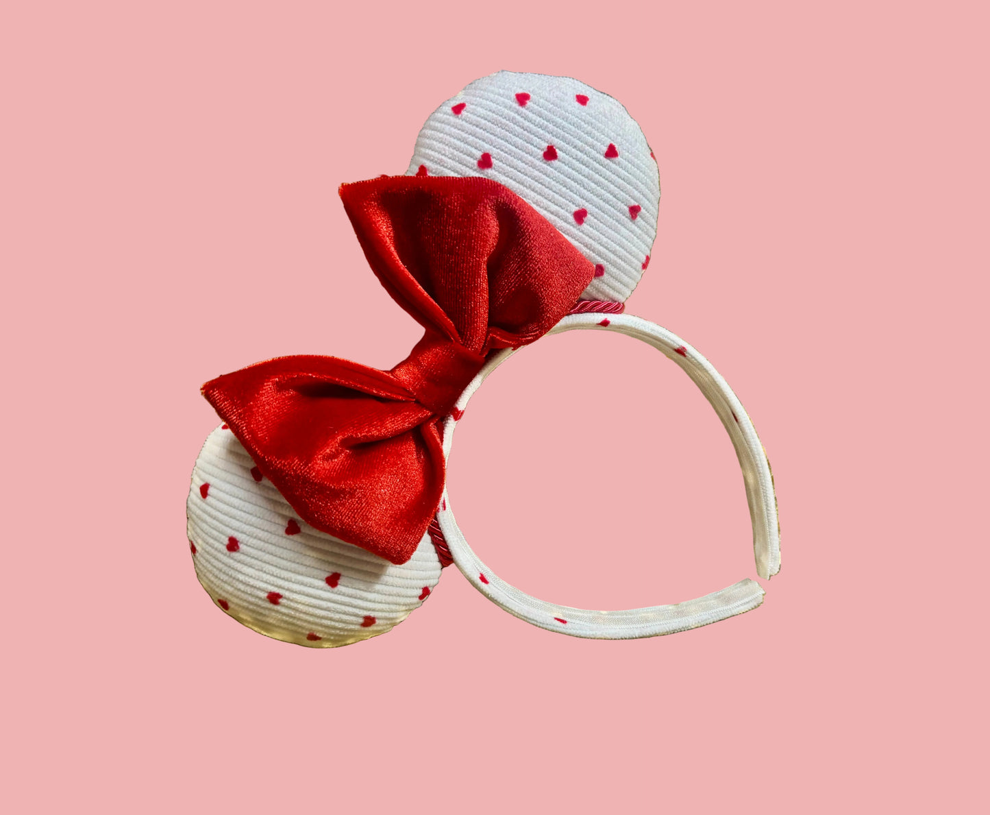 Handmade and ready to ship, Be Mine Custom Ears. Fabric is on ears front and back with red twisted trim along the inner ears and a big puffy plush red bow. The Headband is universal sized and has the same white fabric with hearts pattern on it.