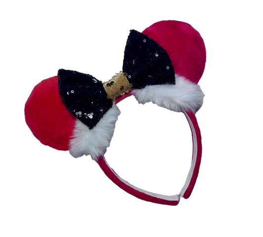 Minnie Mouse ears headband with red plush ears and black bow with gold middle and fluffy white trim on a white background