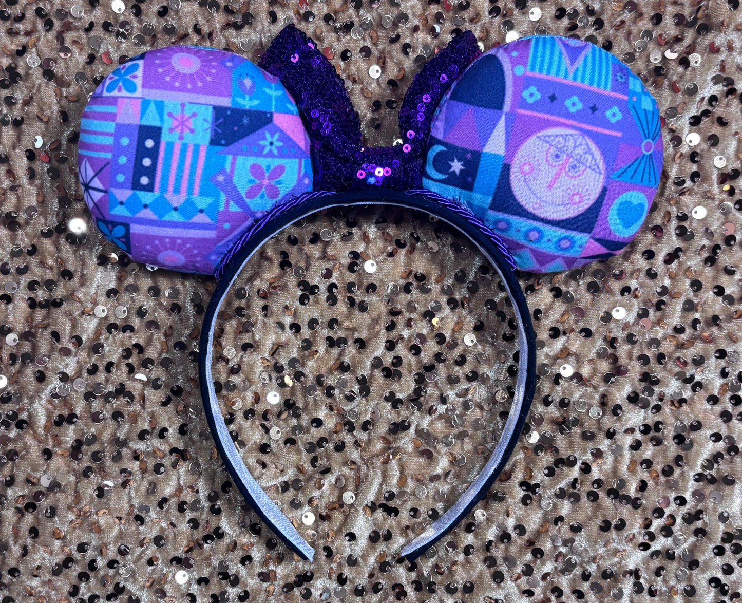 Colorful mouse ears headband on a textured surface