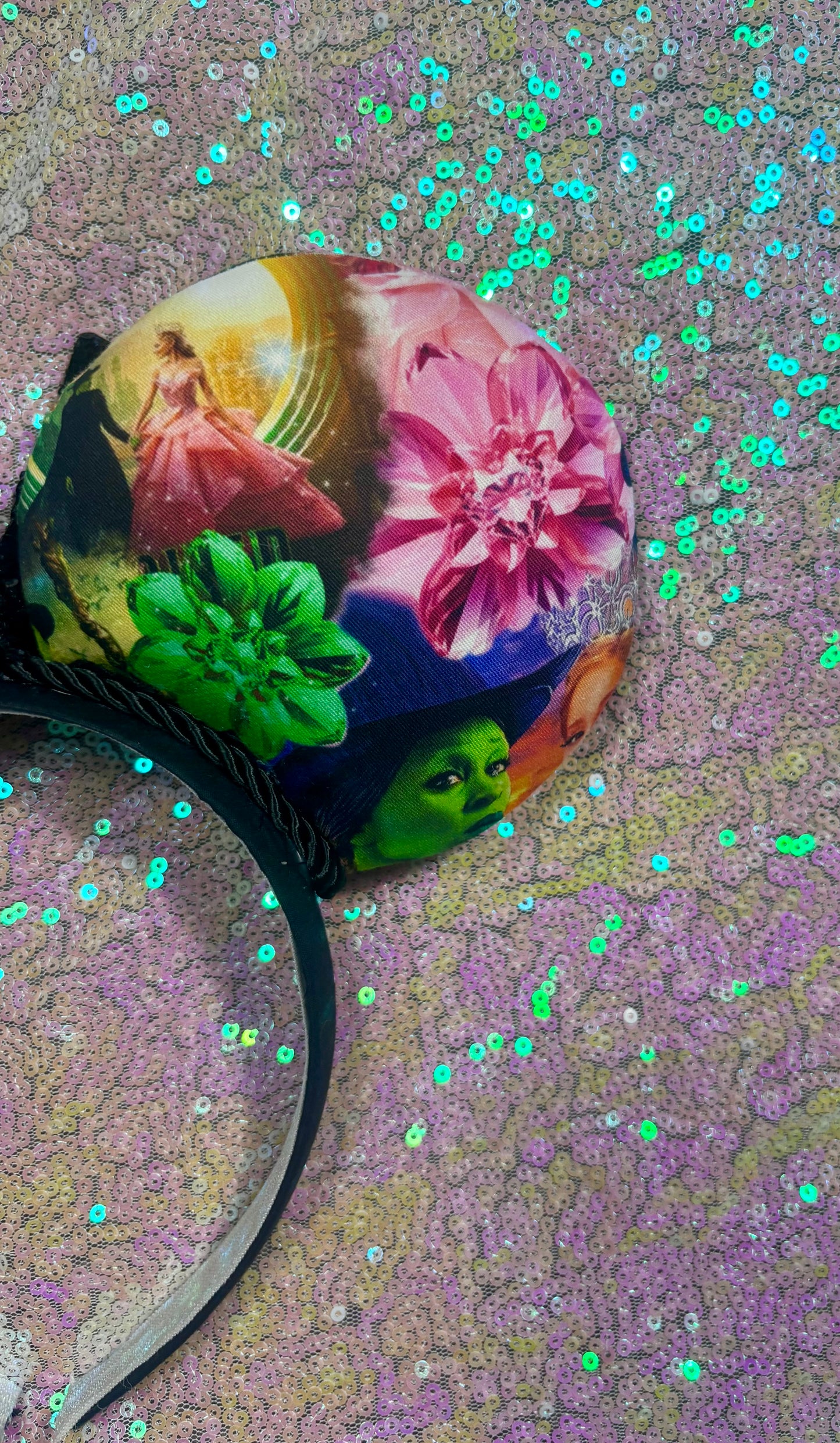 Colorful headband with artistic design on a glittery background