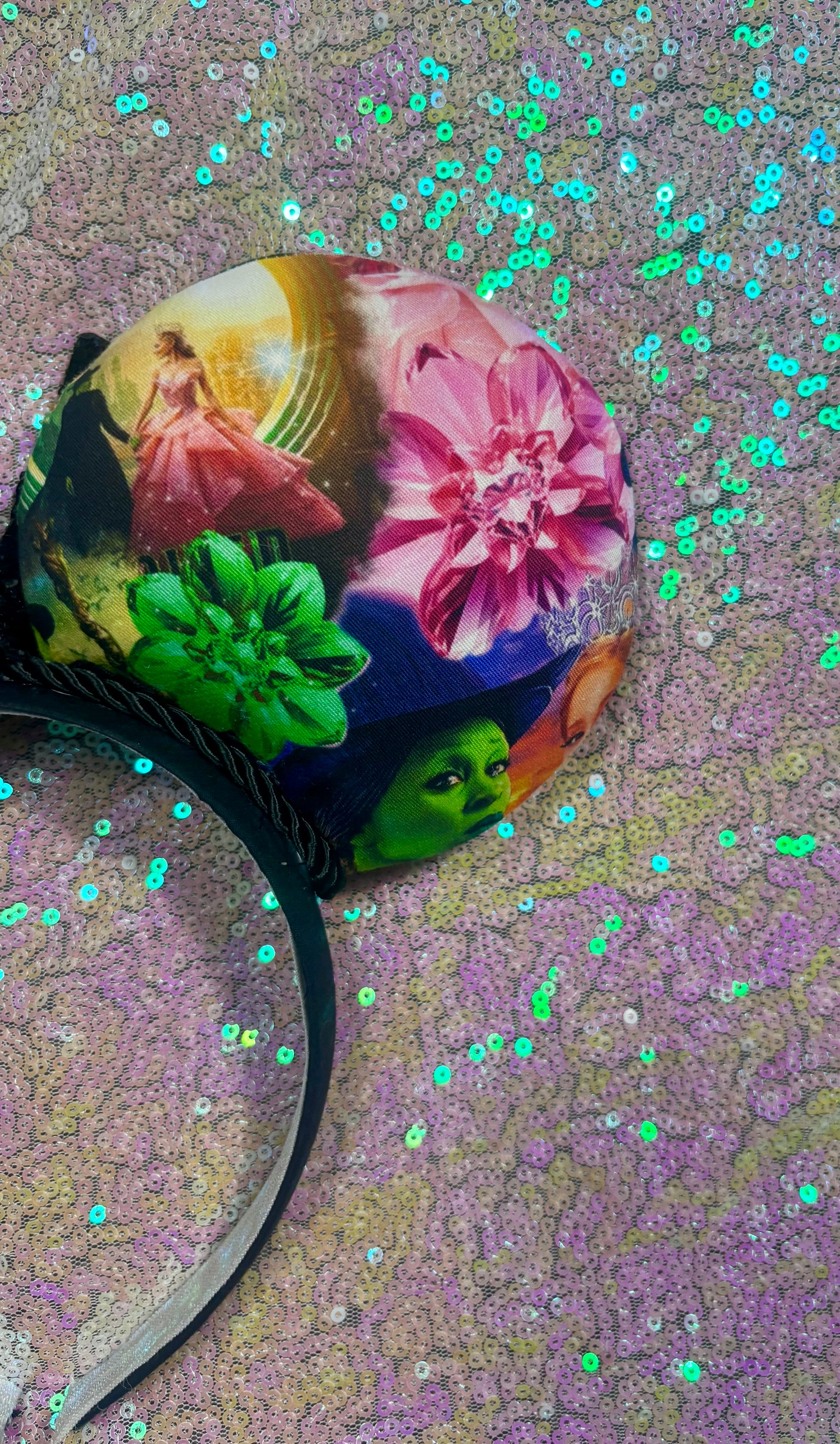 Colorful headband with artistic design on a glittery background