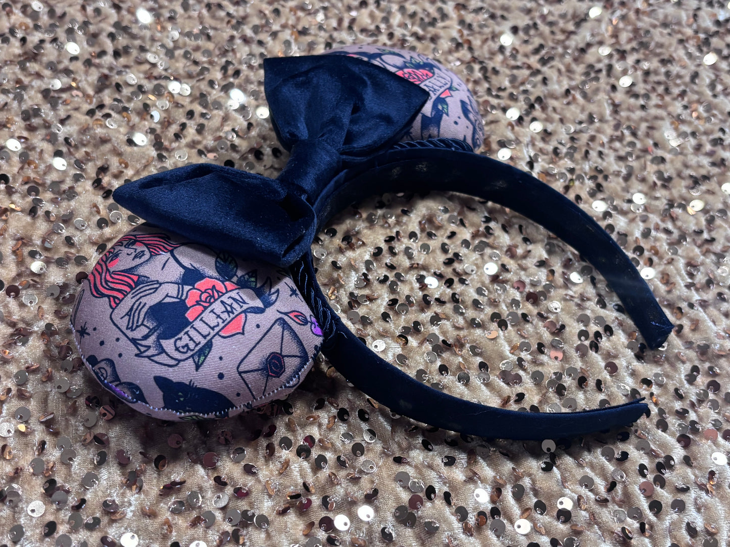 Black velvet bow headband with tattoo-style mouse ears of Gil and Sal on a gold background. Side view of the headband. Made and ready to ship.