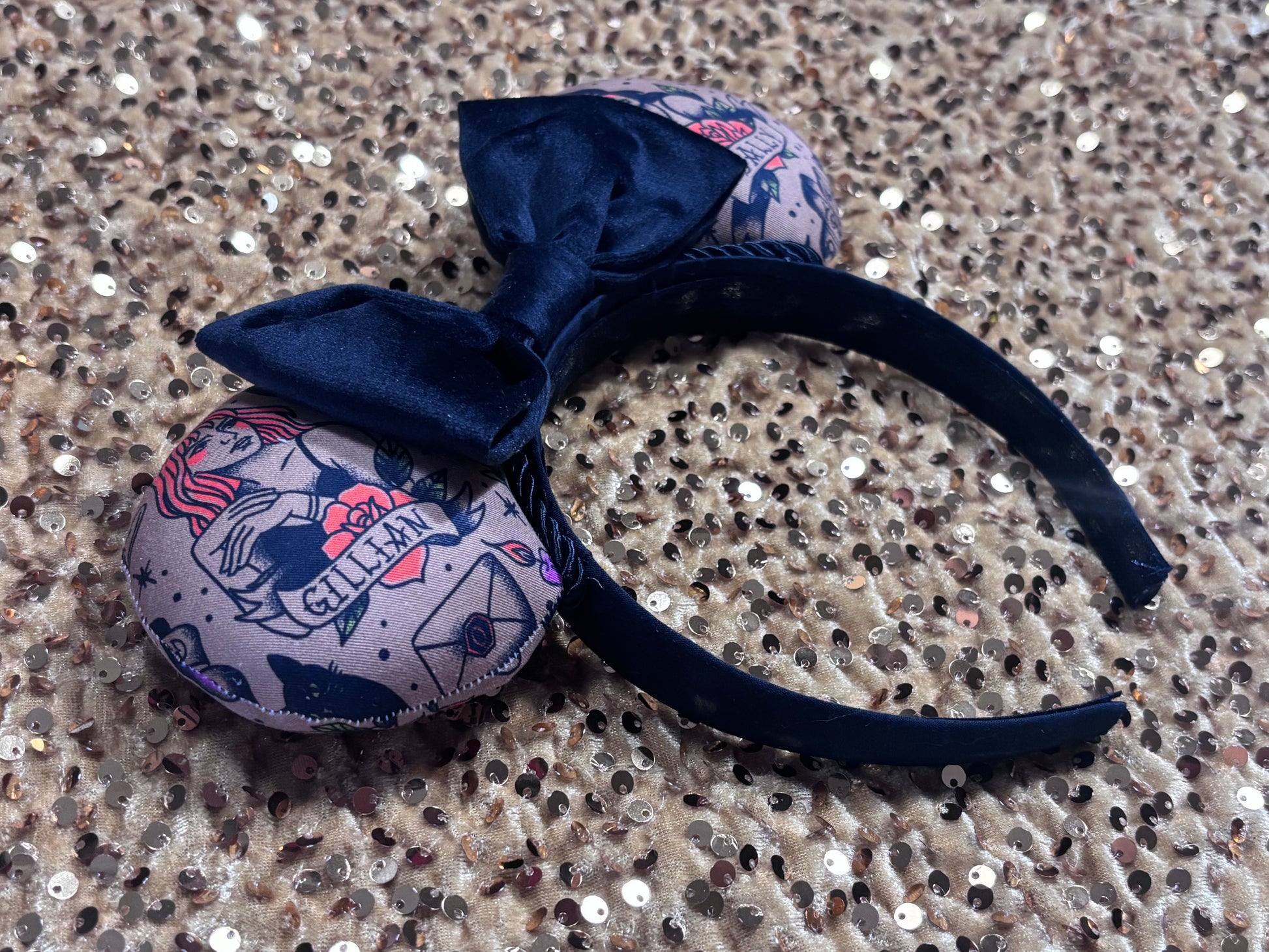 Black velvet bow headband with tattoo-style mouse ears of Gil and Sal on a gold background. Side view of the headband. Made and ready to ship.