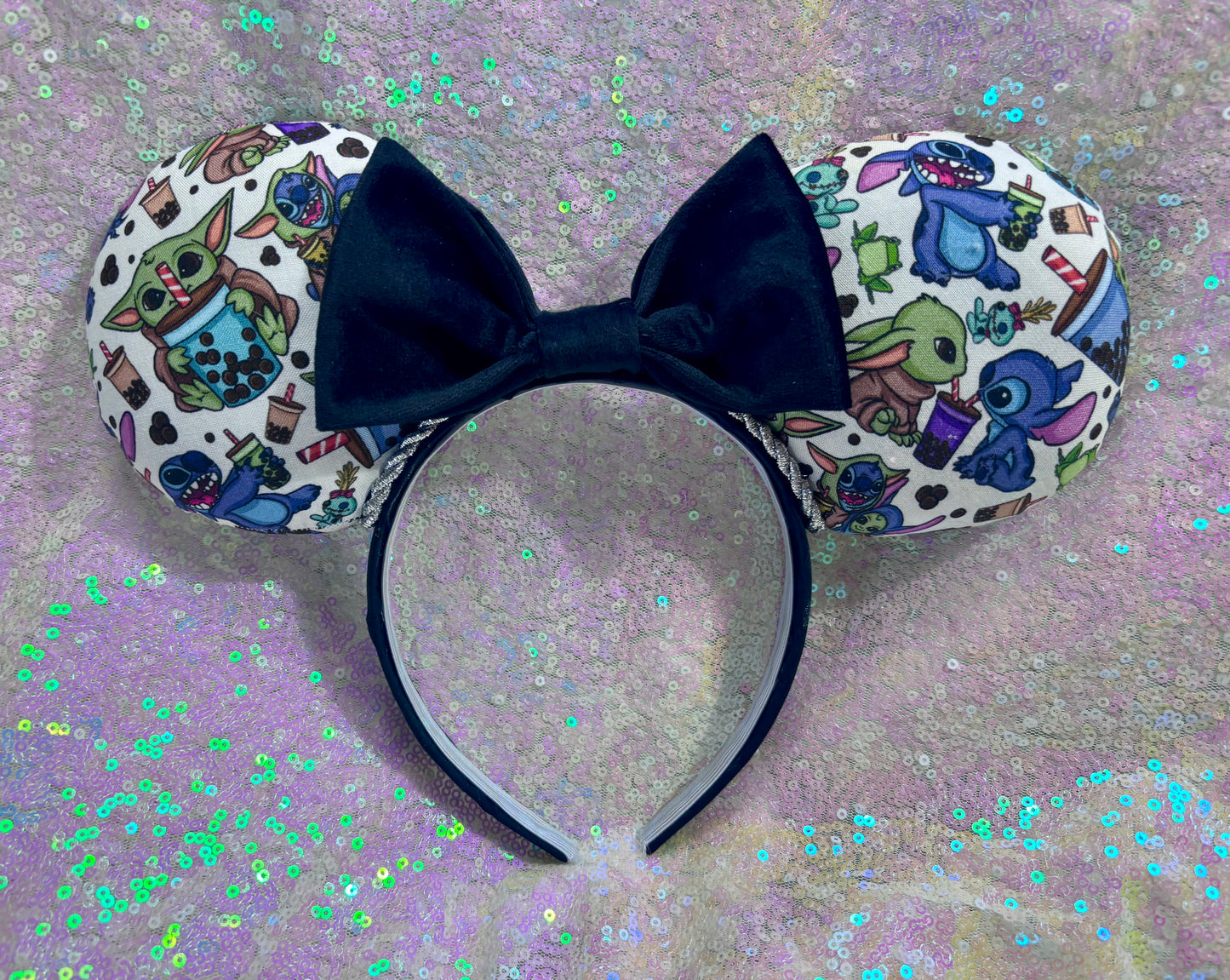 Handmade and ready to ship. Stitch and Baby Yoda are drinking coffee on the front and back with a black velvet bow option. Just request in your order. Shown on a white glitter background.