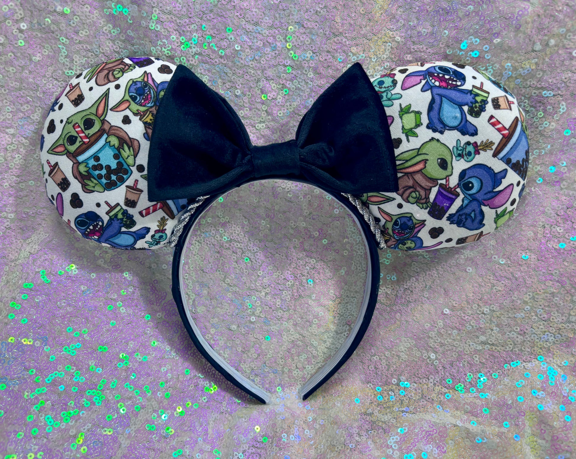 Handmade and ready to ship. Stitch and Baby Yoda are drinking coffee on the front and back with a black velvet bow option. Just request in your order. Shown on a white glitter background.