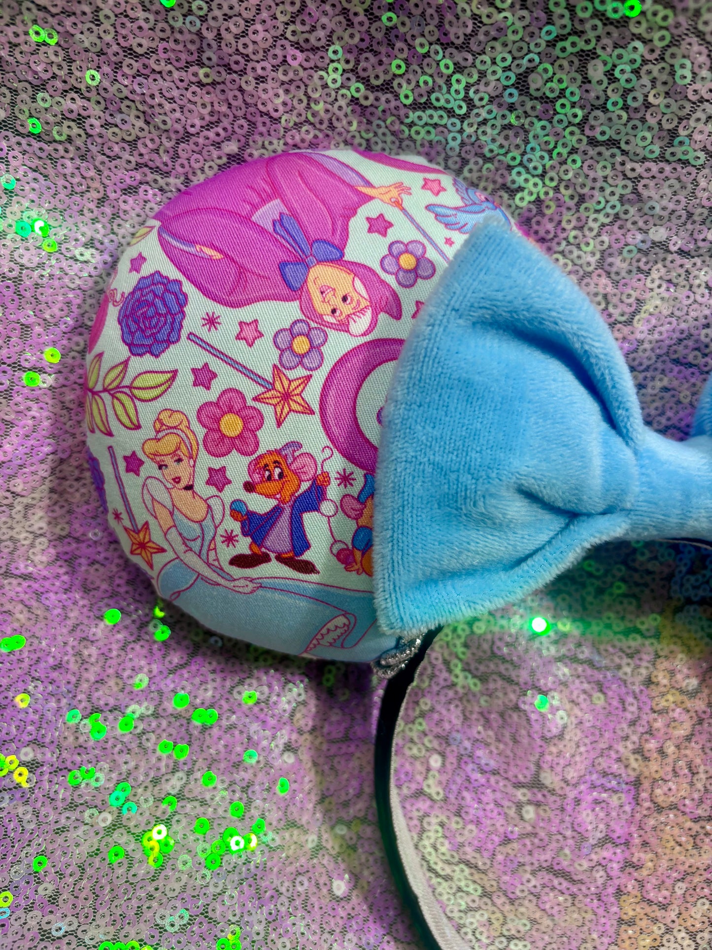 Cindy’s friend’s Mouse ears with a soft plush blue bow on a sequin background. Handmade and ready to ship.