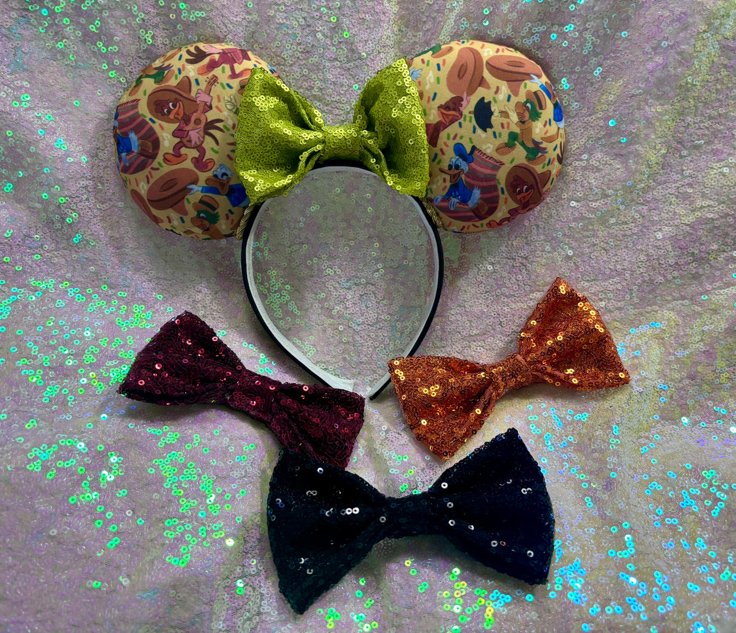 Handmade and ready to ship. These are perfect for Epcot. Three Caballero themed with a lime green sequin bow on a headband making mouse ears. Shown on a white glitter background. Also shown are more bows. I have most colors so I can attach whichever color you prefer.