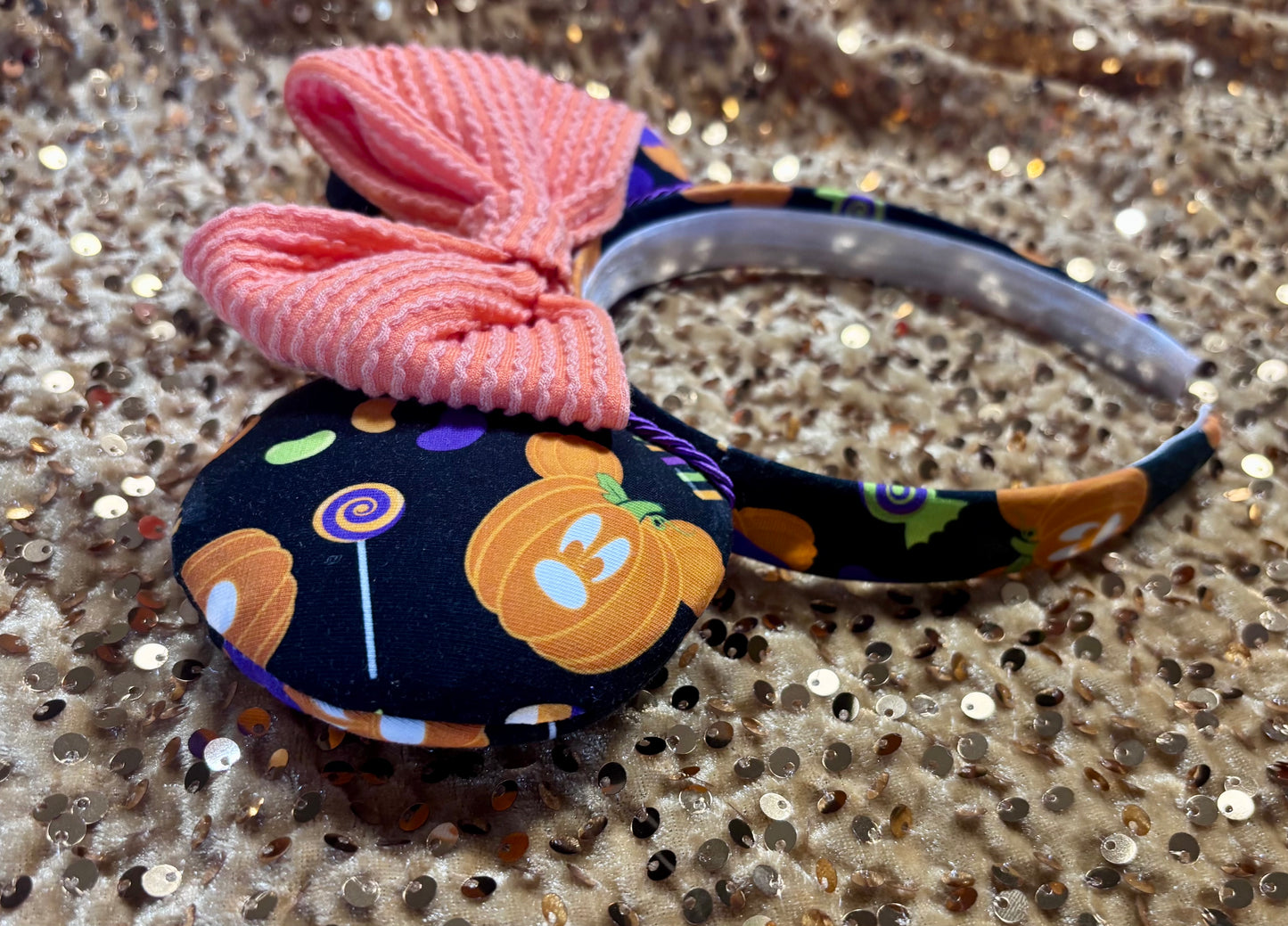 Side view of the handmade mouse ears with Halloween boo to you fabric on ears and the headband. Orange waffle print bow