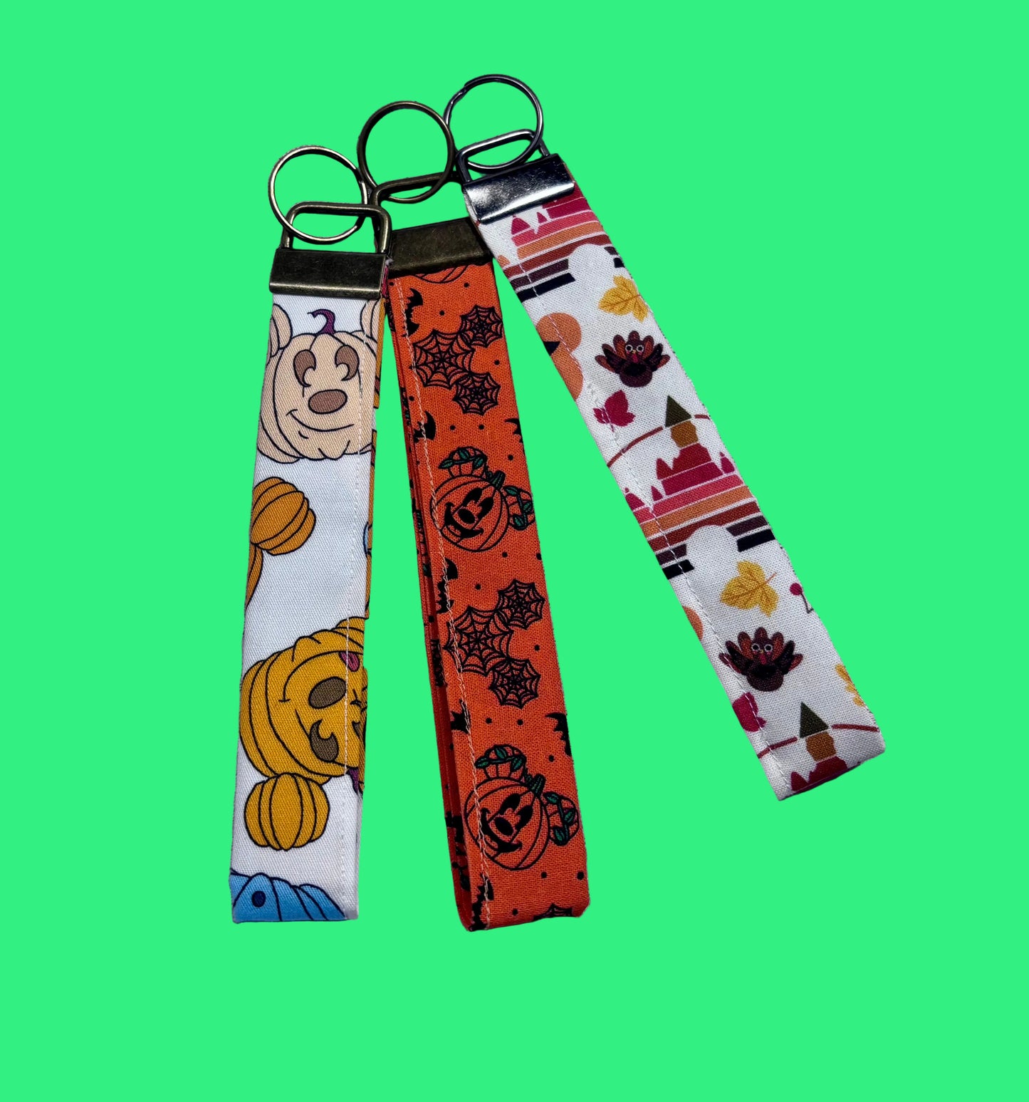 Handmade and ready to ship. Three keychain wristlets with Halloween-themed designs in: Mouse pumpkin, boo to you and thanksgiving fabric designs. 