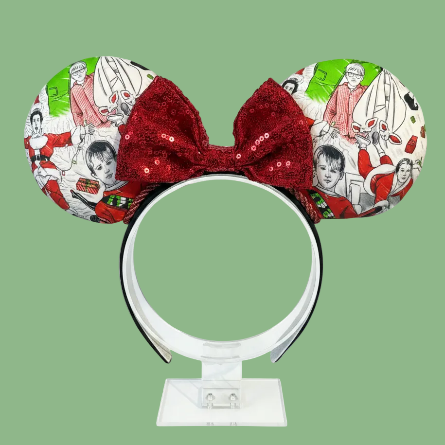 Classic Christmas films inspired fabric on front, back and the headband as well. These are handmade and ready to ship mouse ears with a red sequin bow. Shown on a white background.