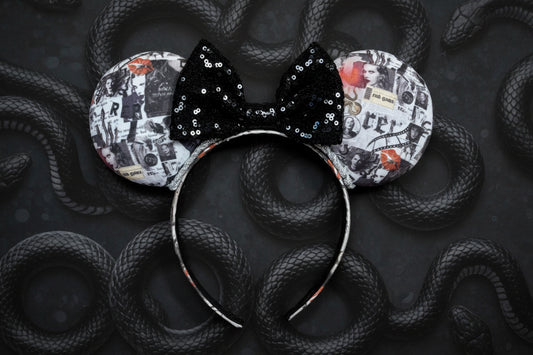 Mouse ears with a black sequin bow and patterned design on a dark background