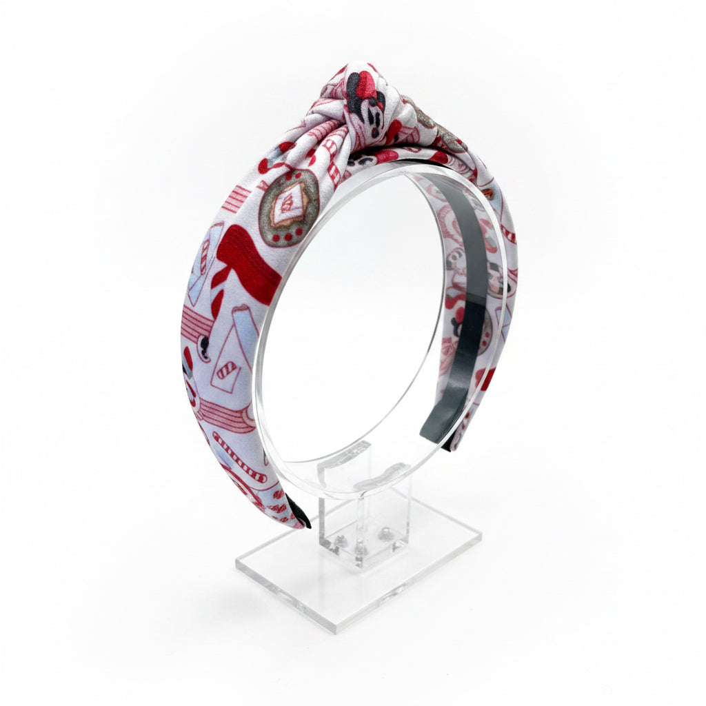Handmade and ready to ship. Stocking Stuffer headband shown on a clear stand. Headband is universal sized.