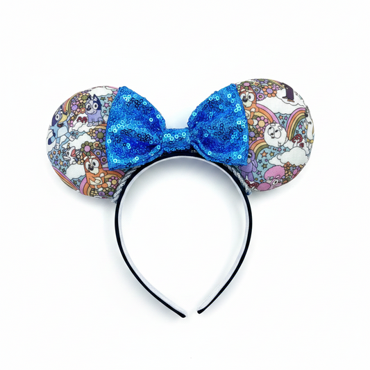 Mouse ears with a blue bow and colorful floral pattern with Bluey and friends on a white background
