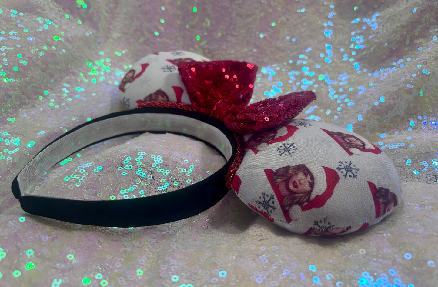 Headband with red bow and patterned fabric on a glittery background