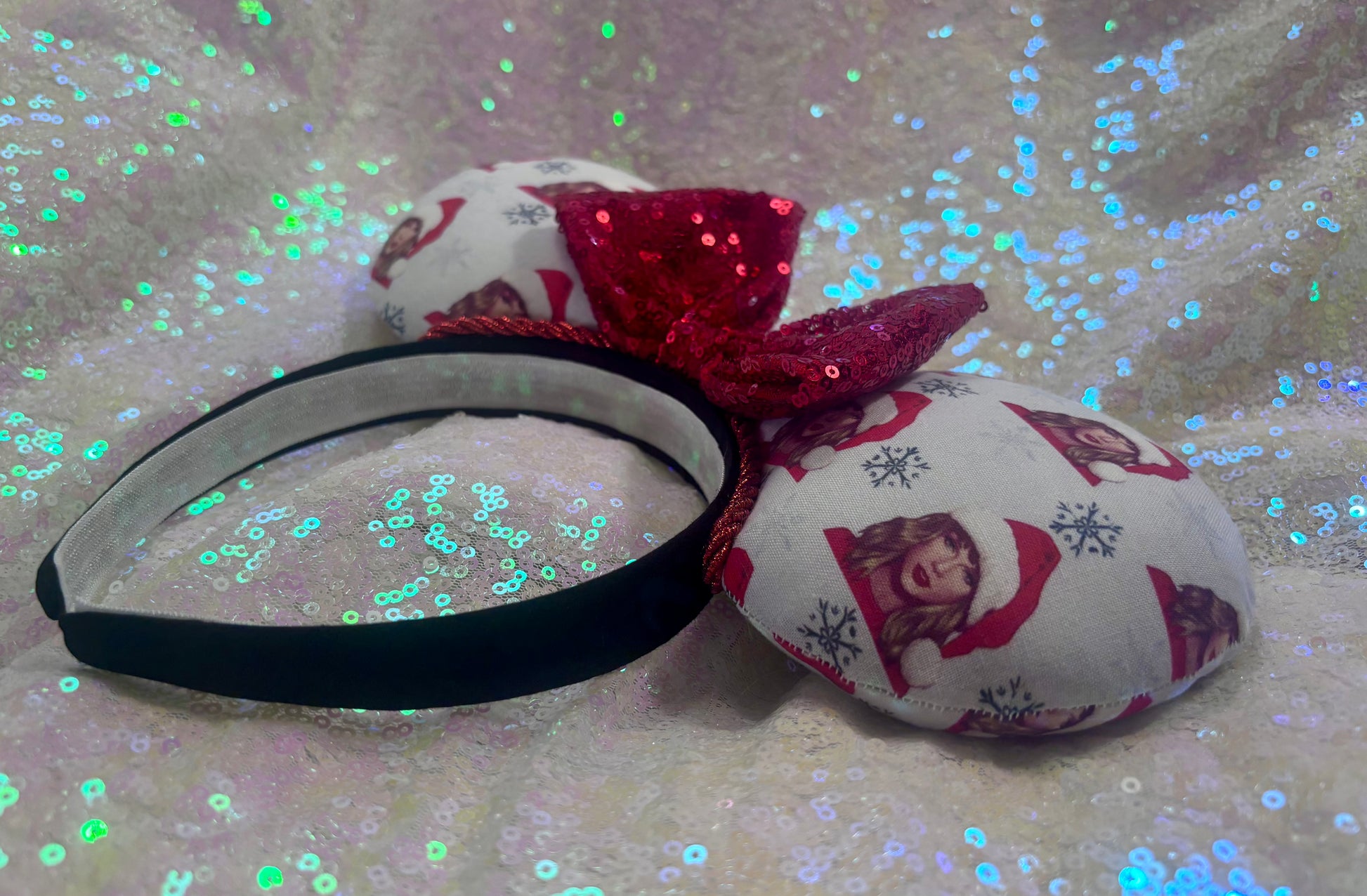 Headband with red bow and patterned fabric on a glittery background